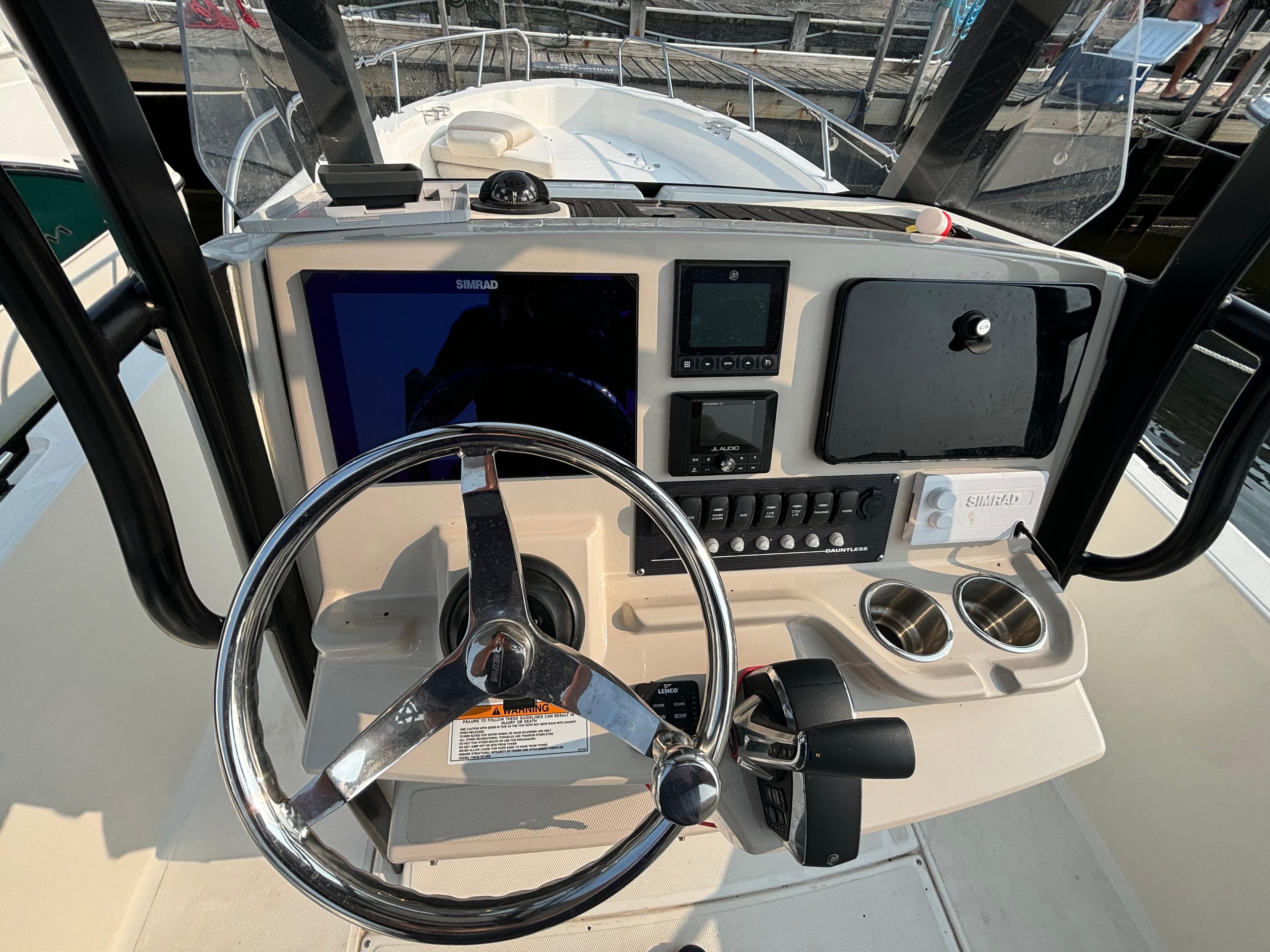 2023 Boston Whaler 250 Dauntless helm with steering wheel and navigation controls.
