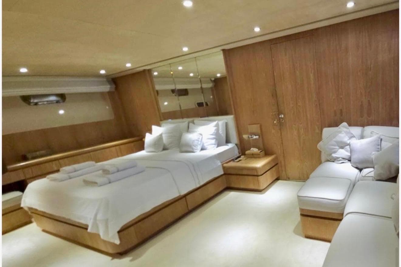 Luxurious bedroom interior on 1992 Cantieri di Pisa Akhir 30S yacht, featuring elegant wood paneling.