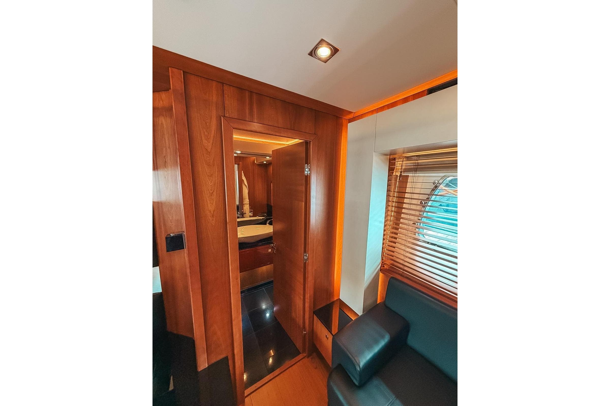 Luxurious interior of 2010 Sunseeker Predator 84 yacht, featuring wooden paneling and modern design.