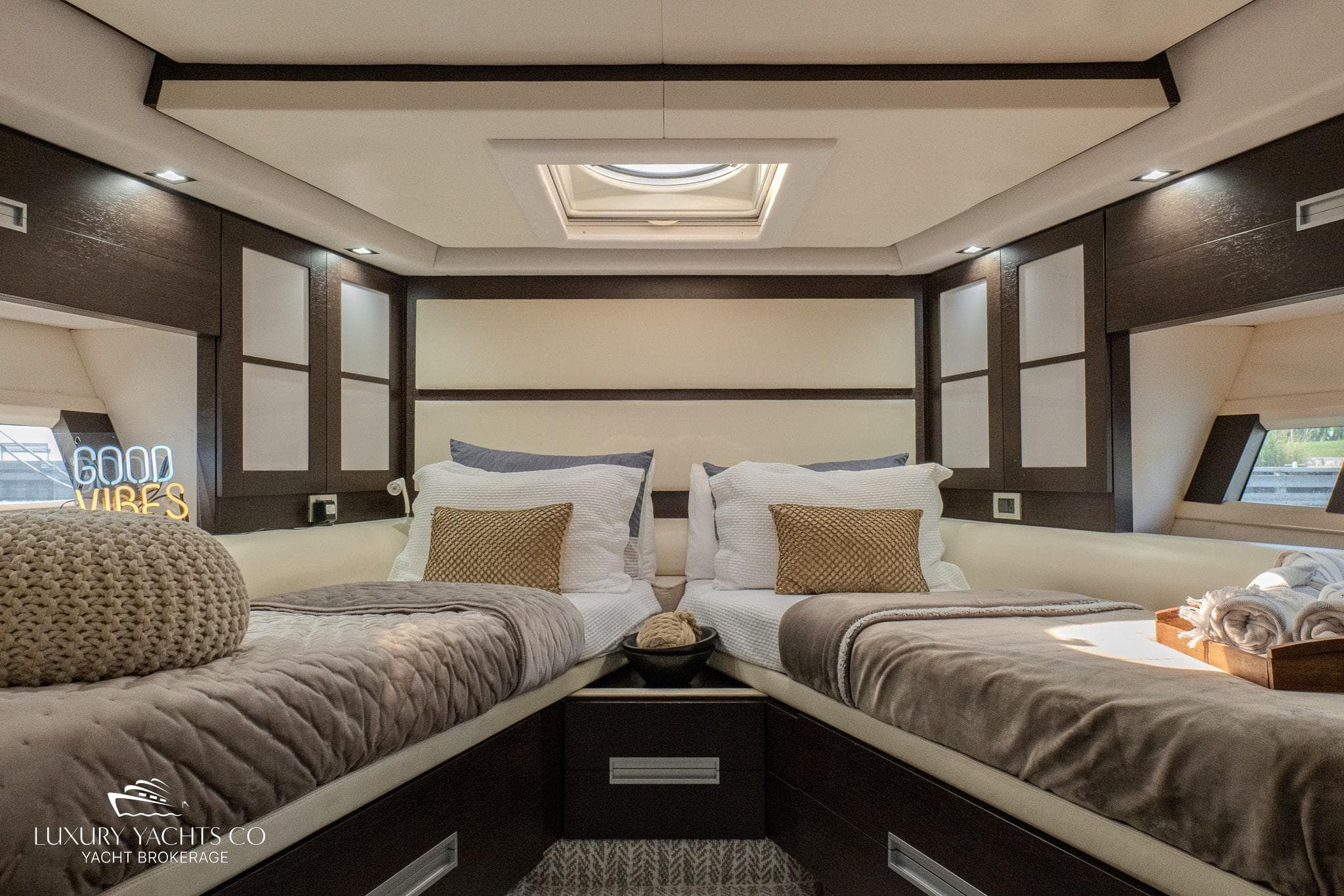 Luxurious bedroom interior of 2010 Azimut 62S yacht with twin beds and elegant decor.