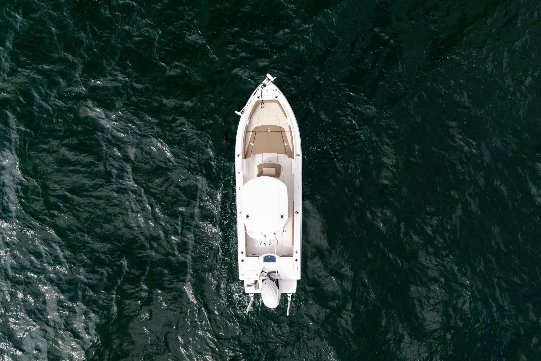 Overhead view of 2023 Everglades 243 Center Console boat on dark water.