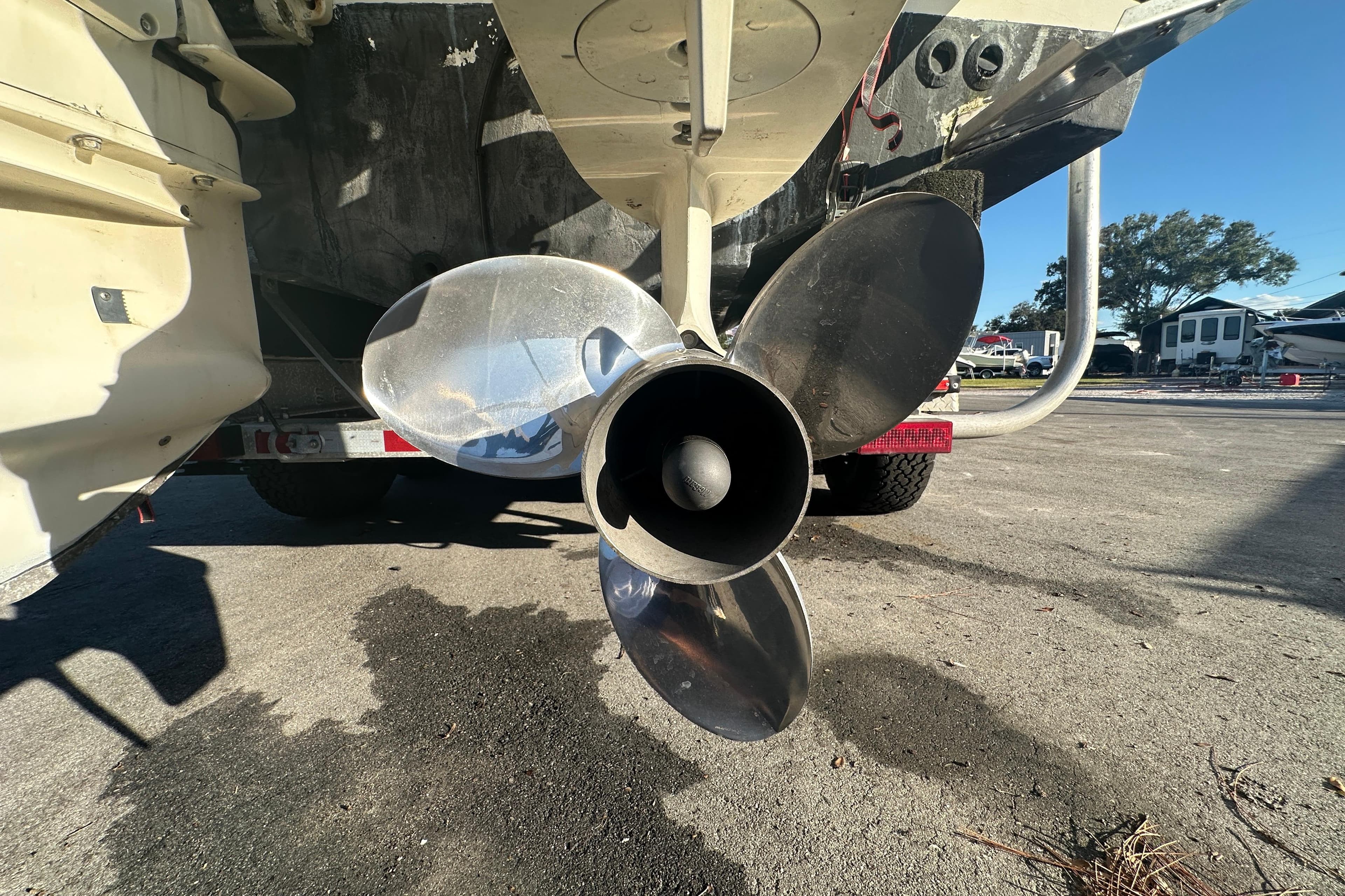Close-up of a 2001 Boston Whaler 23 Conquest boat propeller on a trailer.