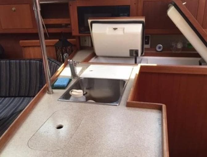 Interior of 2001 Hunter 380 yacht showing kitchen sink and countertop area.