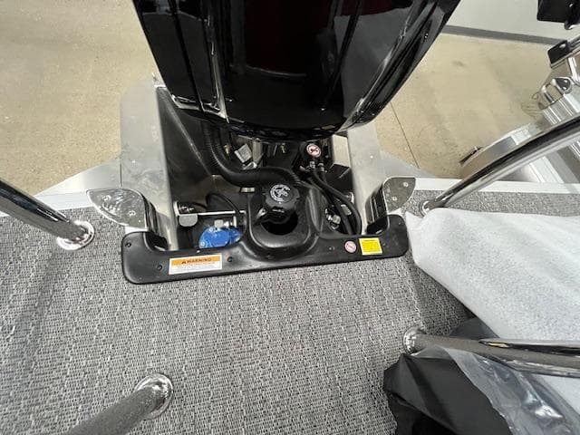 2025 Barletta ARIA 20QC boat engine compartment with carpeted flooring and metal railings.