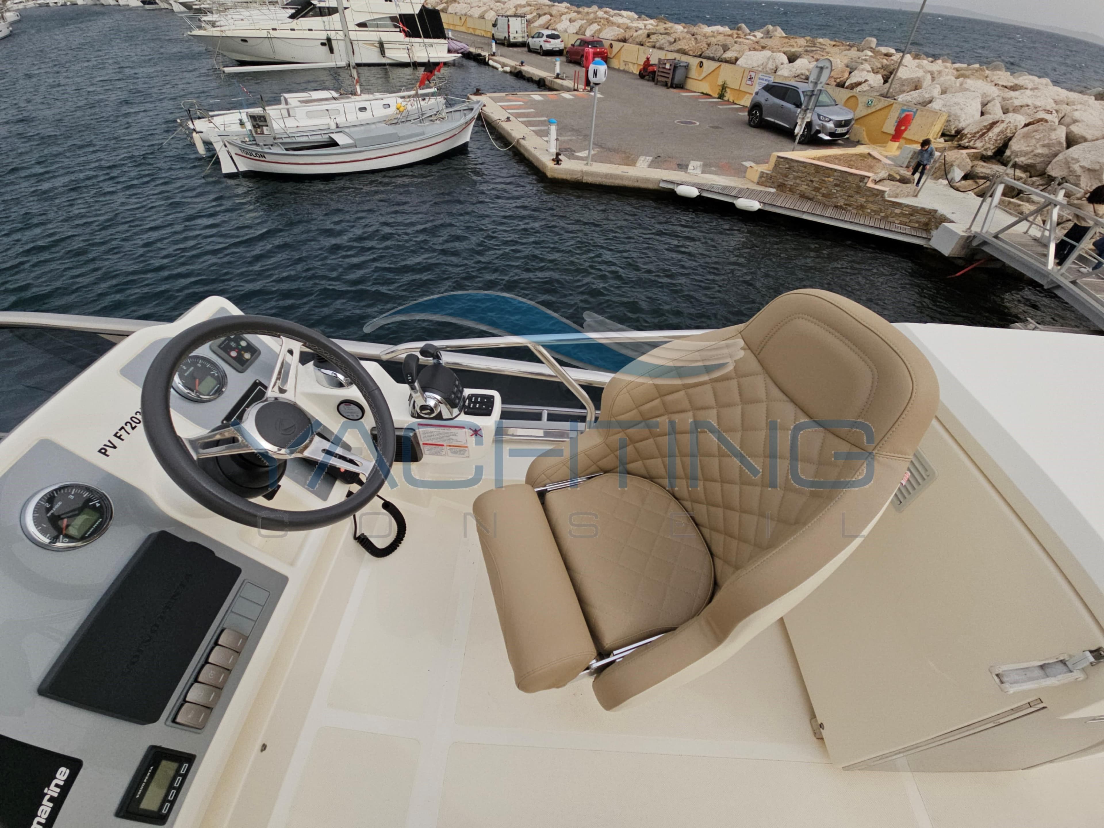 Flybridge helm of 2018 Absolute 45 FLY yacht at marina.