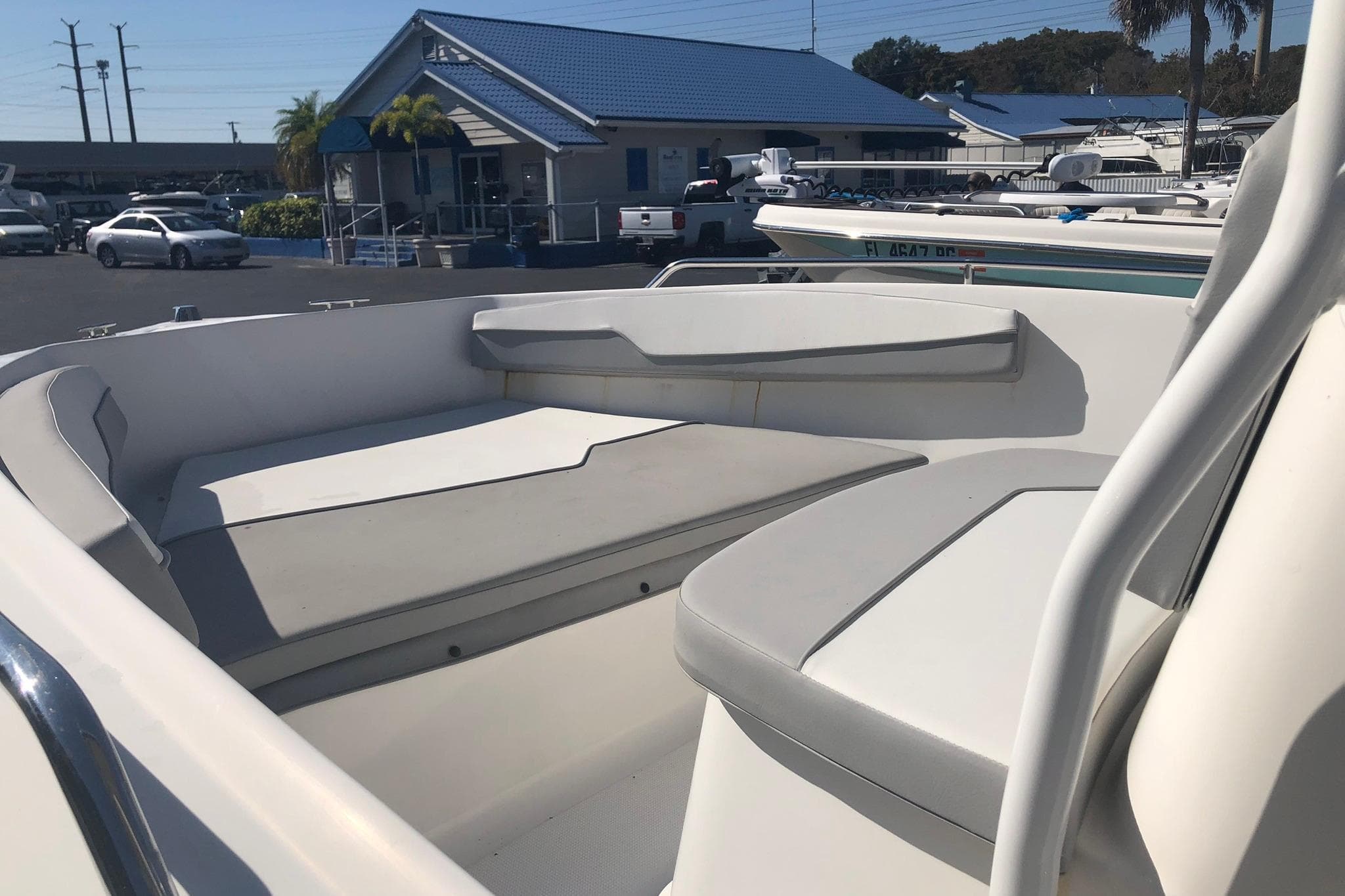 2022 Key Largo 1800 Center Console boat interior with seating, parked at a marina.