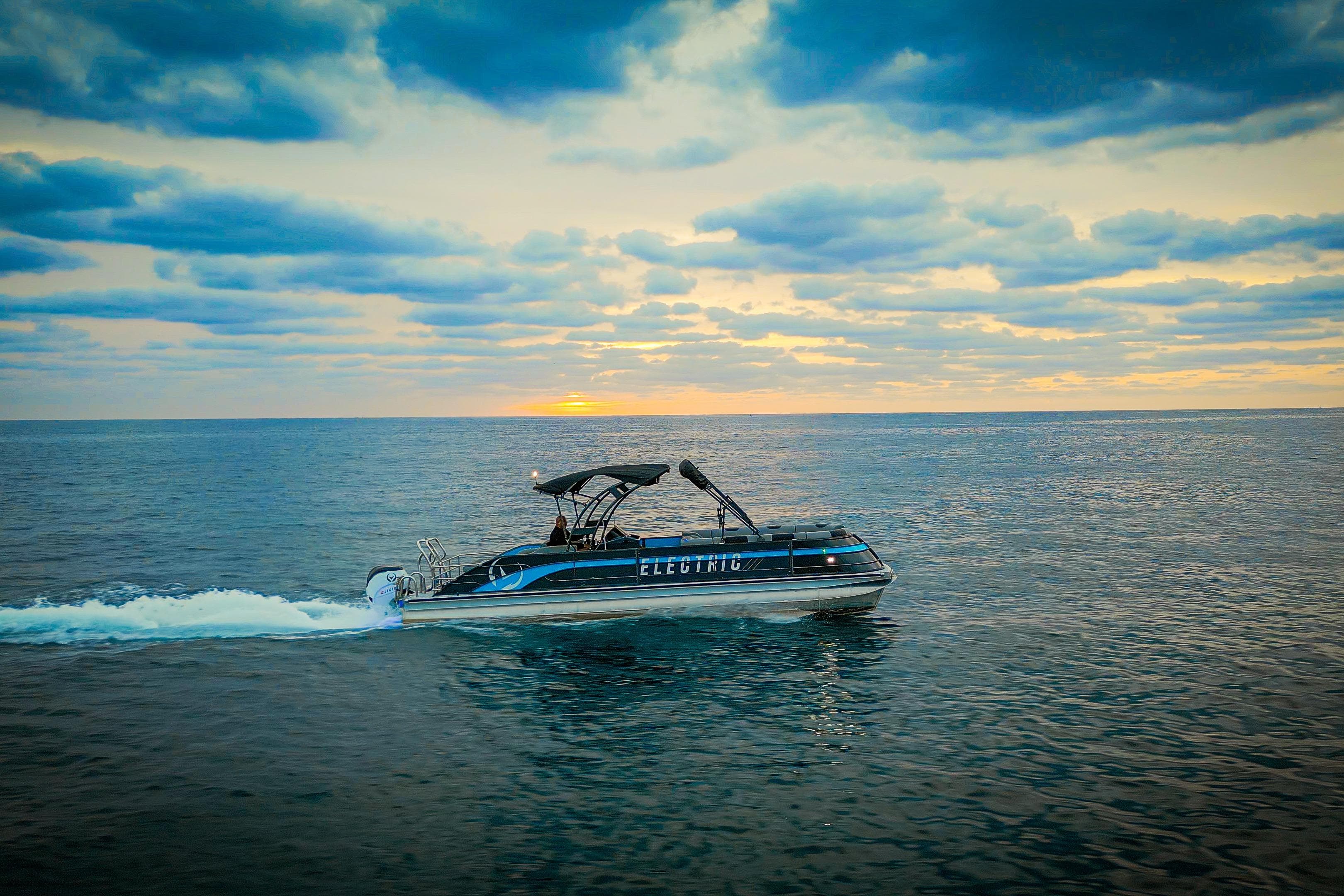 Electric Vision Marine Technologies V30 boat cruising at sunset, 2025 model.
