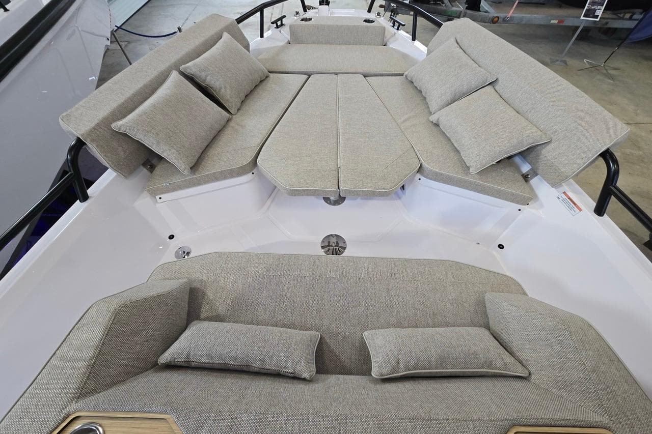 Luxurious seating area on 2026 Axopar 29 XC Cross Cabin boat, featuring plush cushions.
