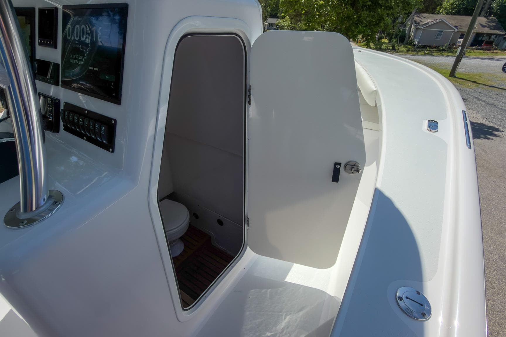 2025 Weaver 25 boat interior with open cabin door and visible controls.
