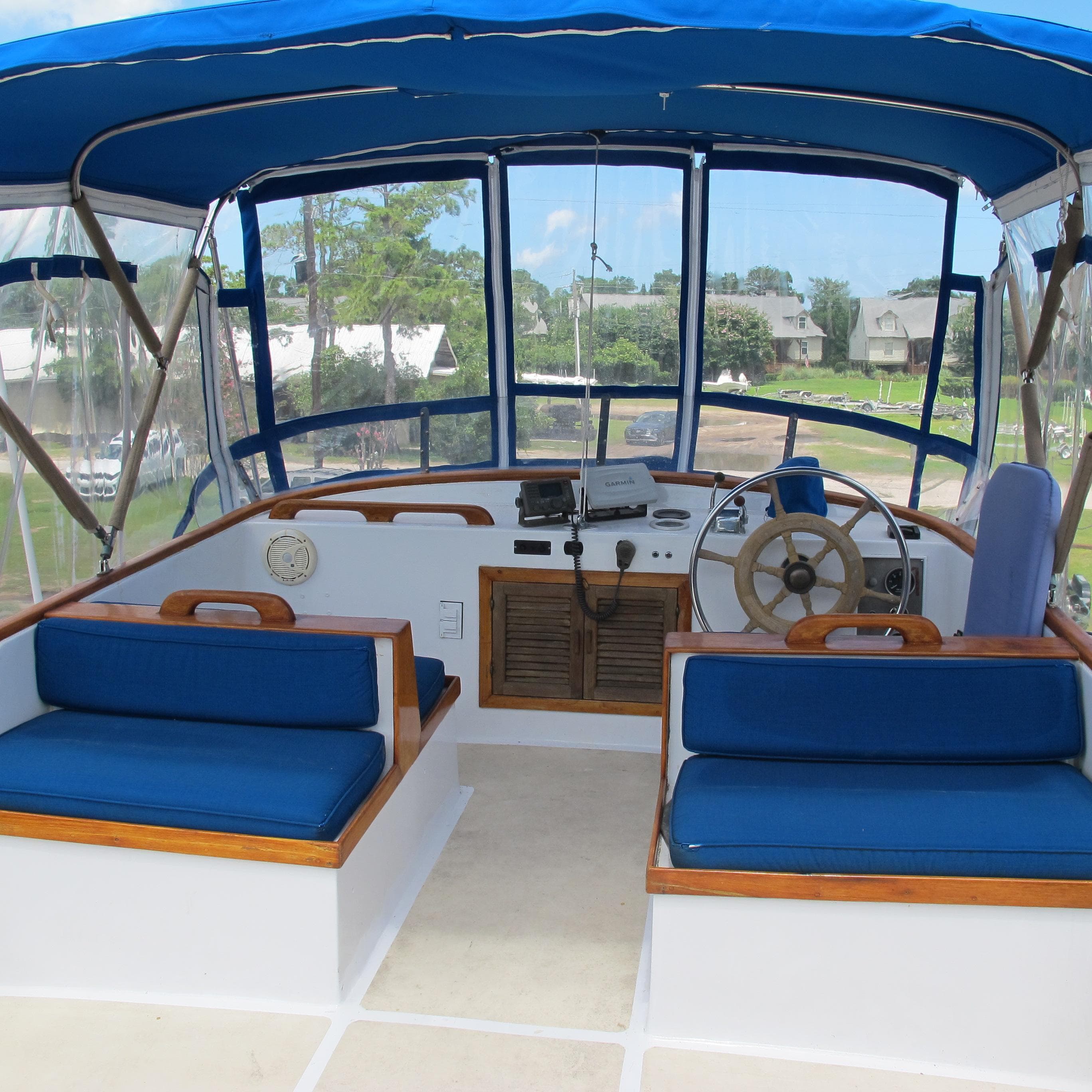 1981 Albin 36 boat cockpit with blue seating and steering wheel.