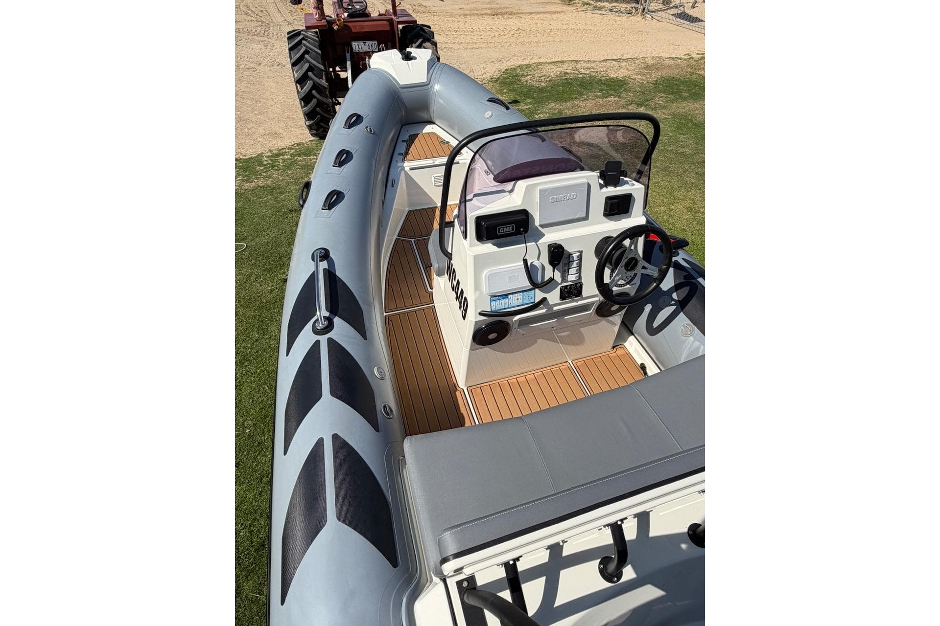 2022 Brig Navigator 485 boat interior with steering console and seating, displayed on grass.
