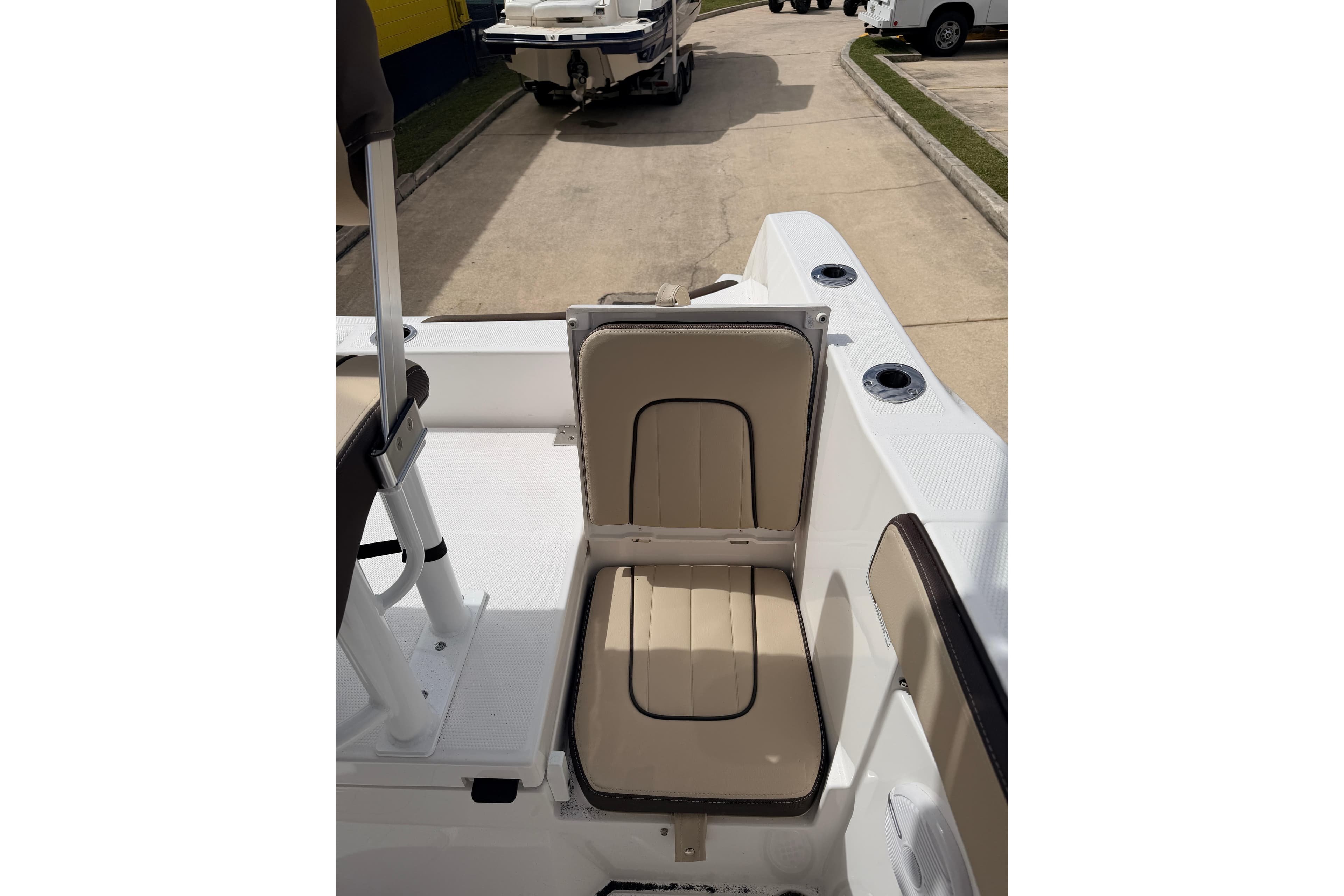 2026 Yamaha Boats 222 FSH Sport interior seating detail, showcasing beige upholstery.