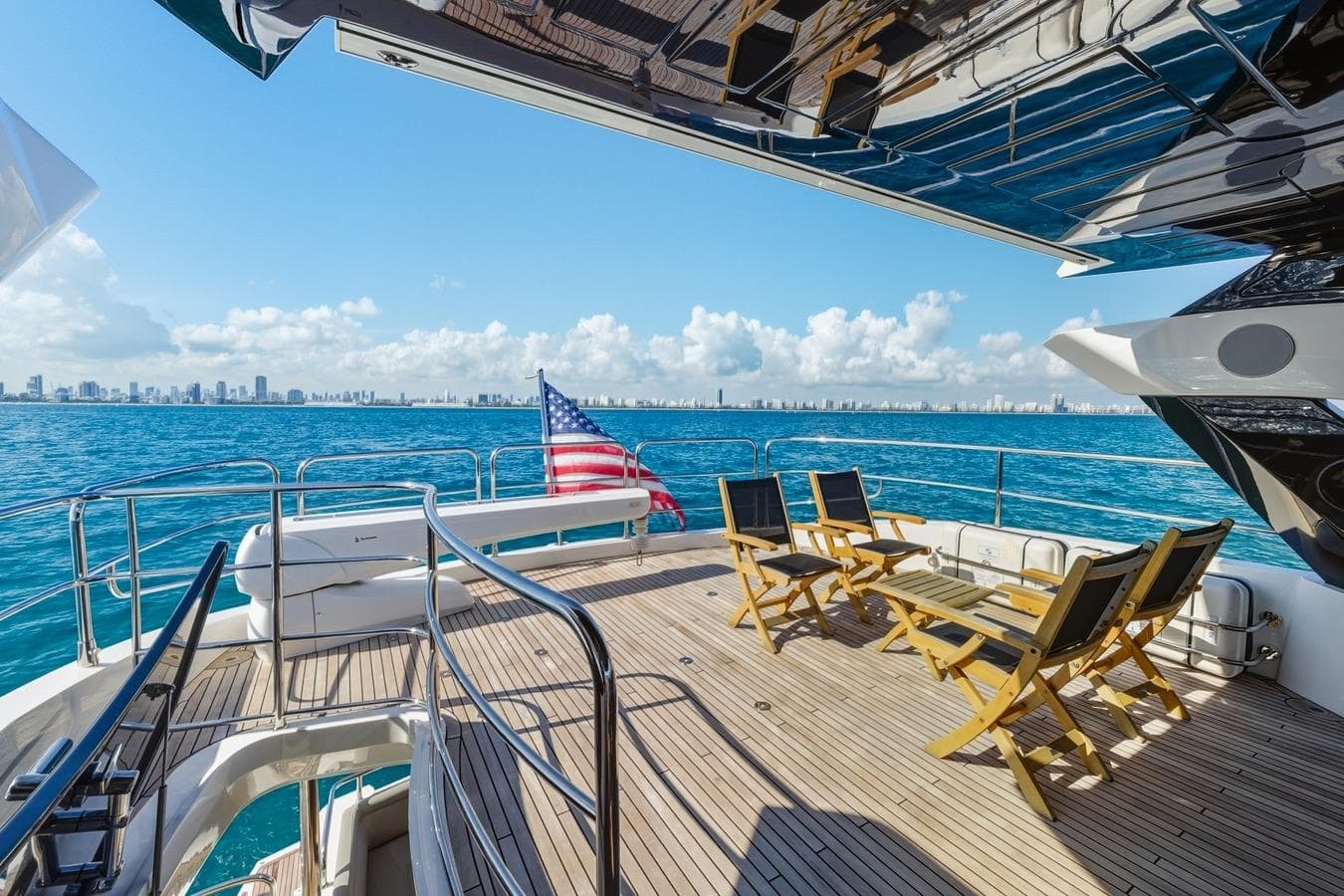 Luxurious 2022 Sunseeker Motoryacht deck with ocean view and city skyline.