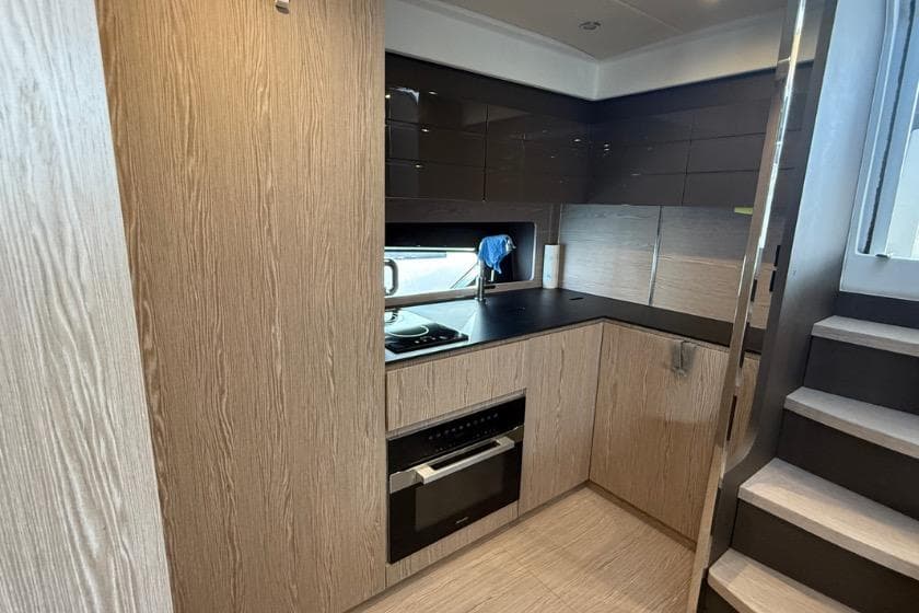 Modern kitchen interior of 2023 Azimut Atlantis 45 yacht with sleek cabinetry and appliances.