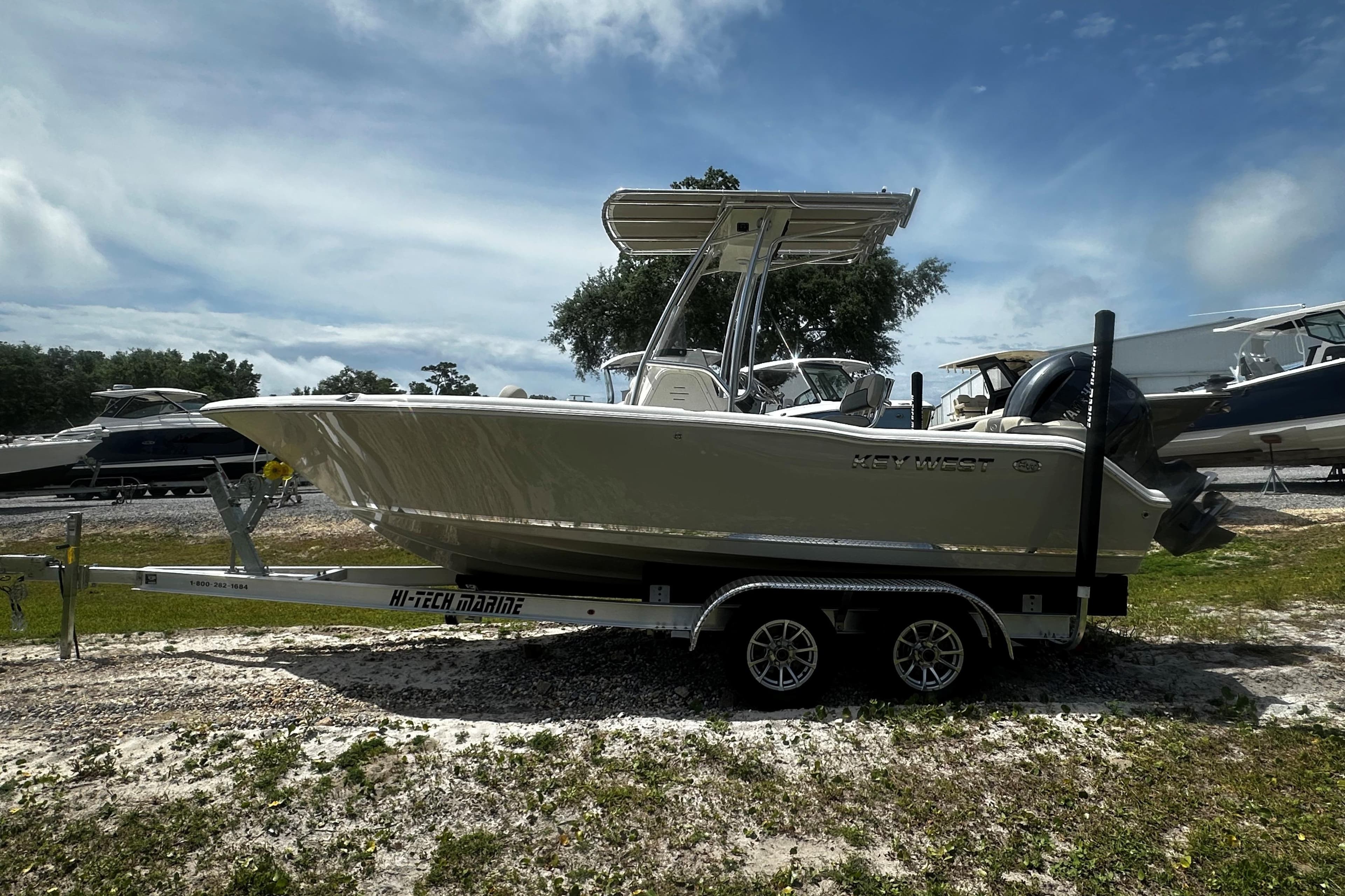 2026 Key West 203 FS boat on trailer, parked outdoors under a cloudy sky.