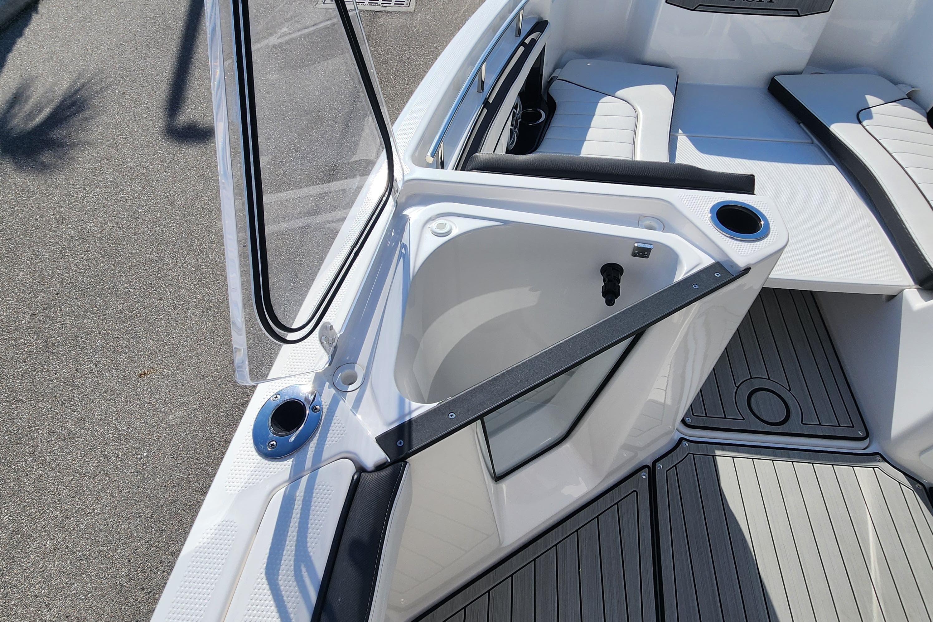 2022 Yamaha 255 FSH Sport E boat interior with seating and storage compartment.