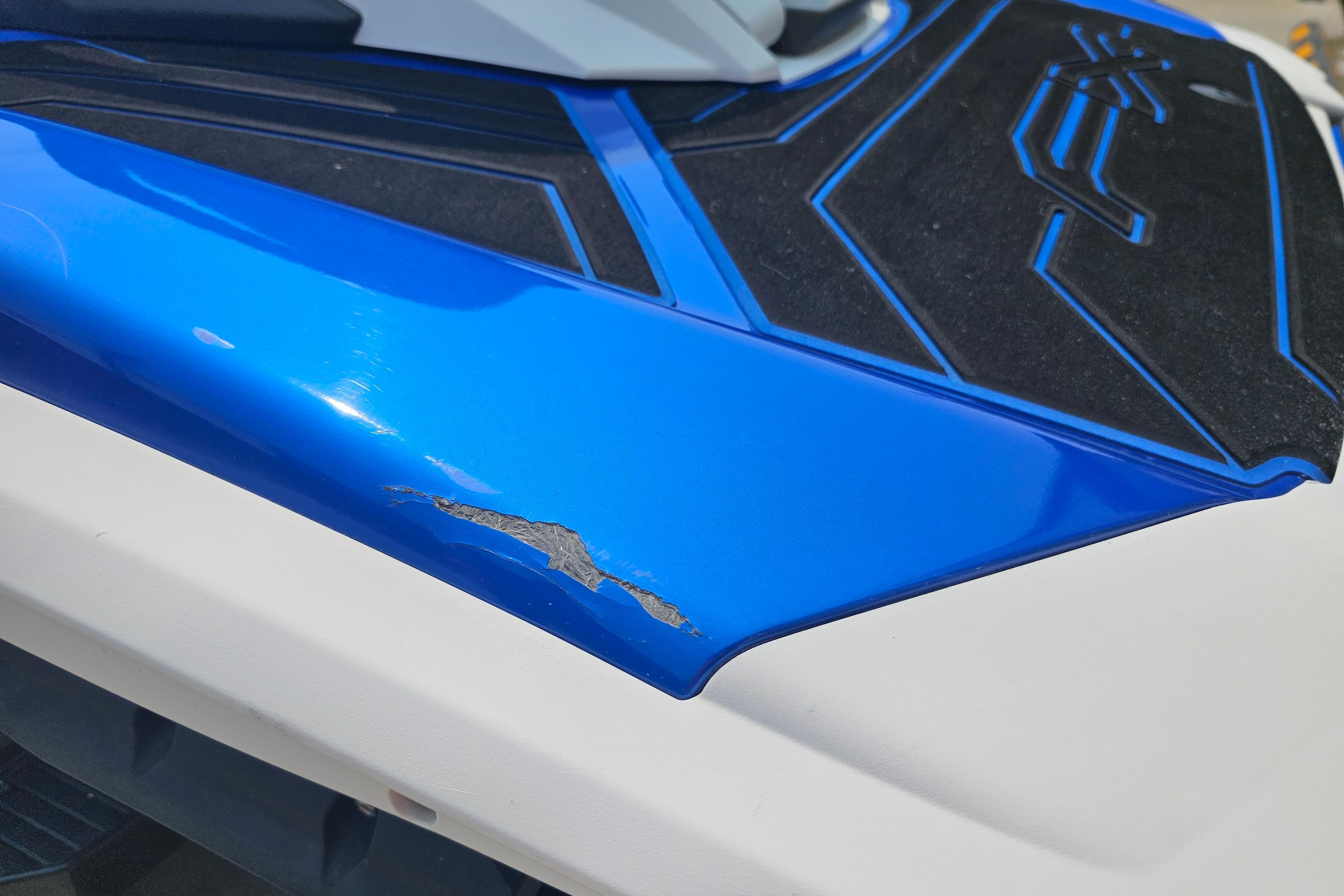 2021 Yamaha WaveRunner FX Cruiser HO with blue paint damage on the body.