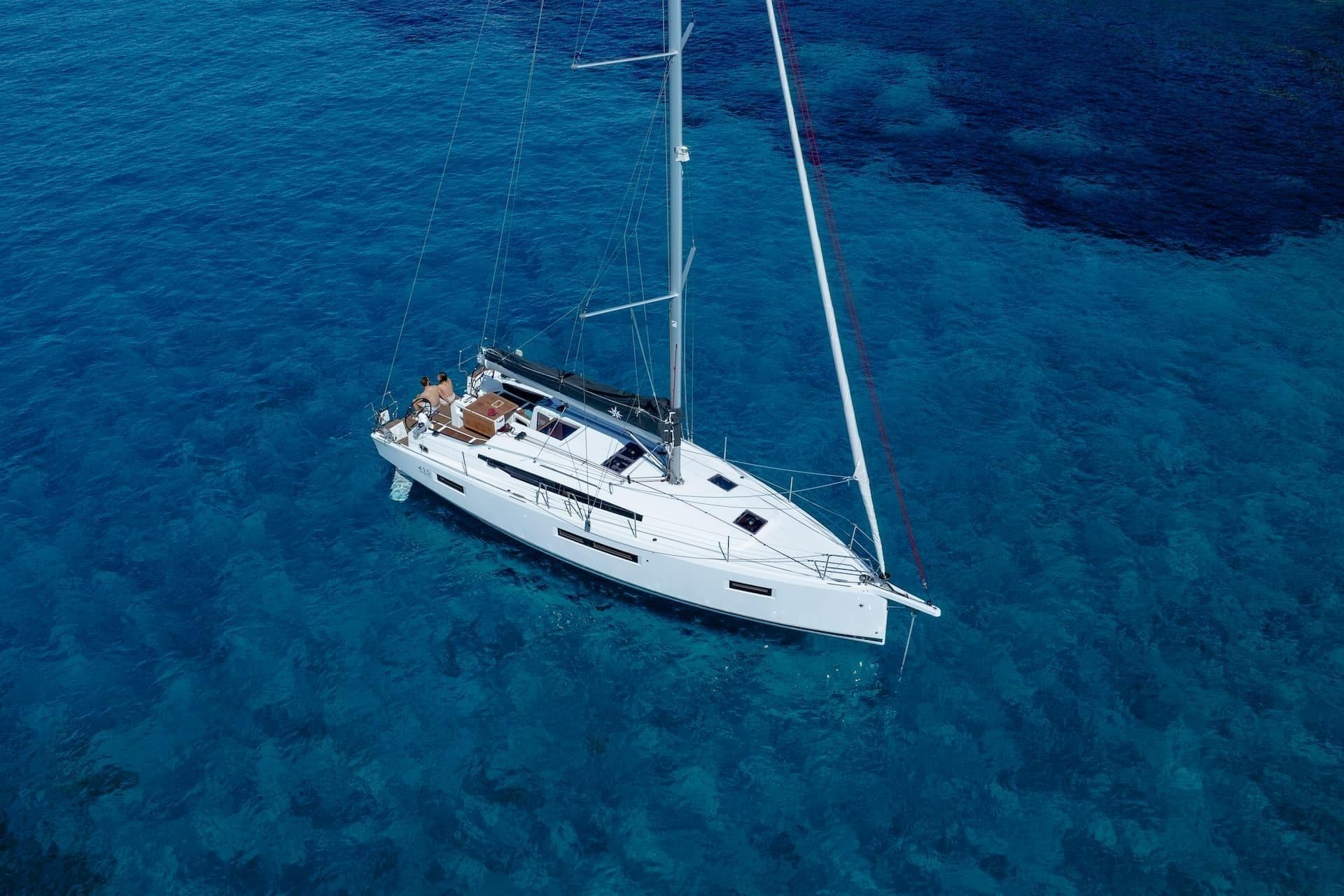 2026 Jeanneau Sun Odyssey 415 sailing on clear blue water.
