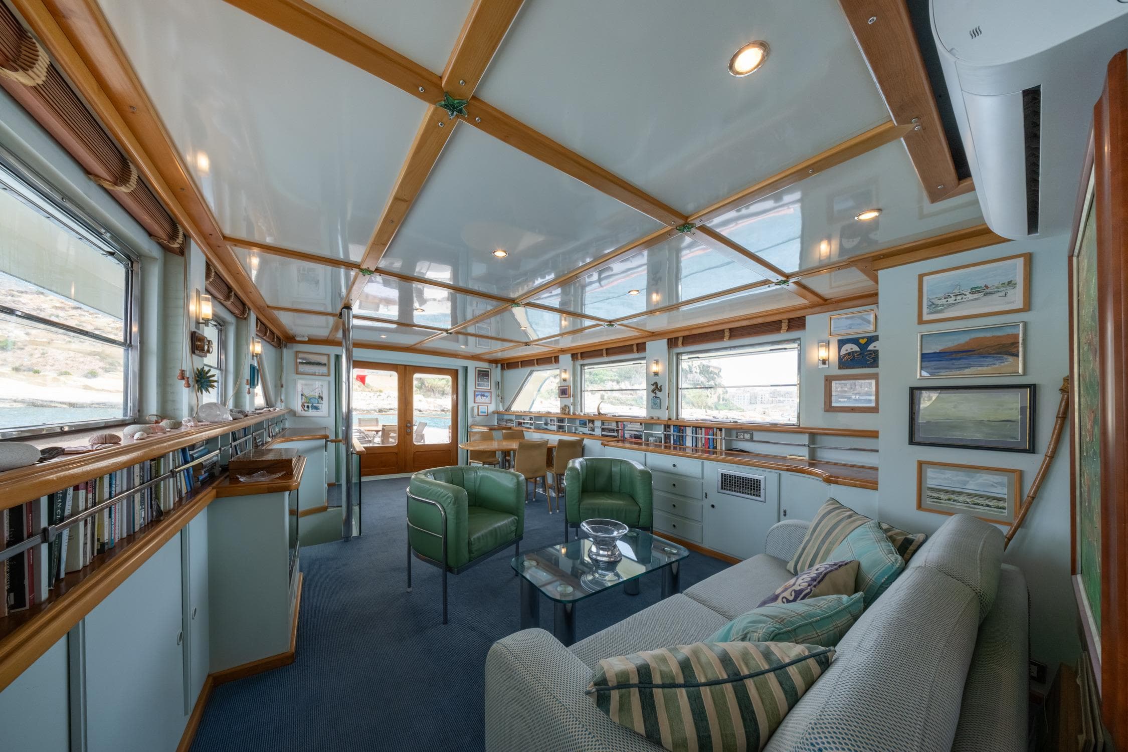 Luxurious 1972 Custom Siccna yacht interior with elegant seating, large windows, and stylish decor.