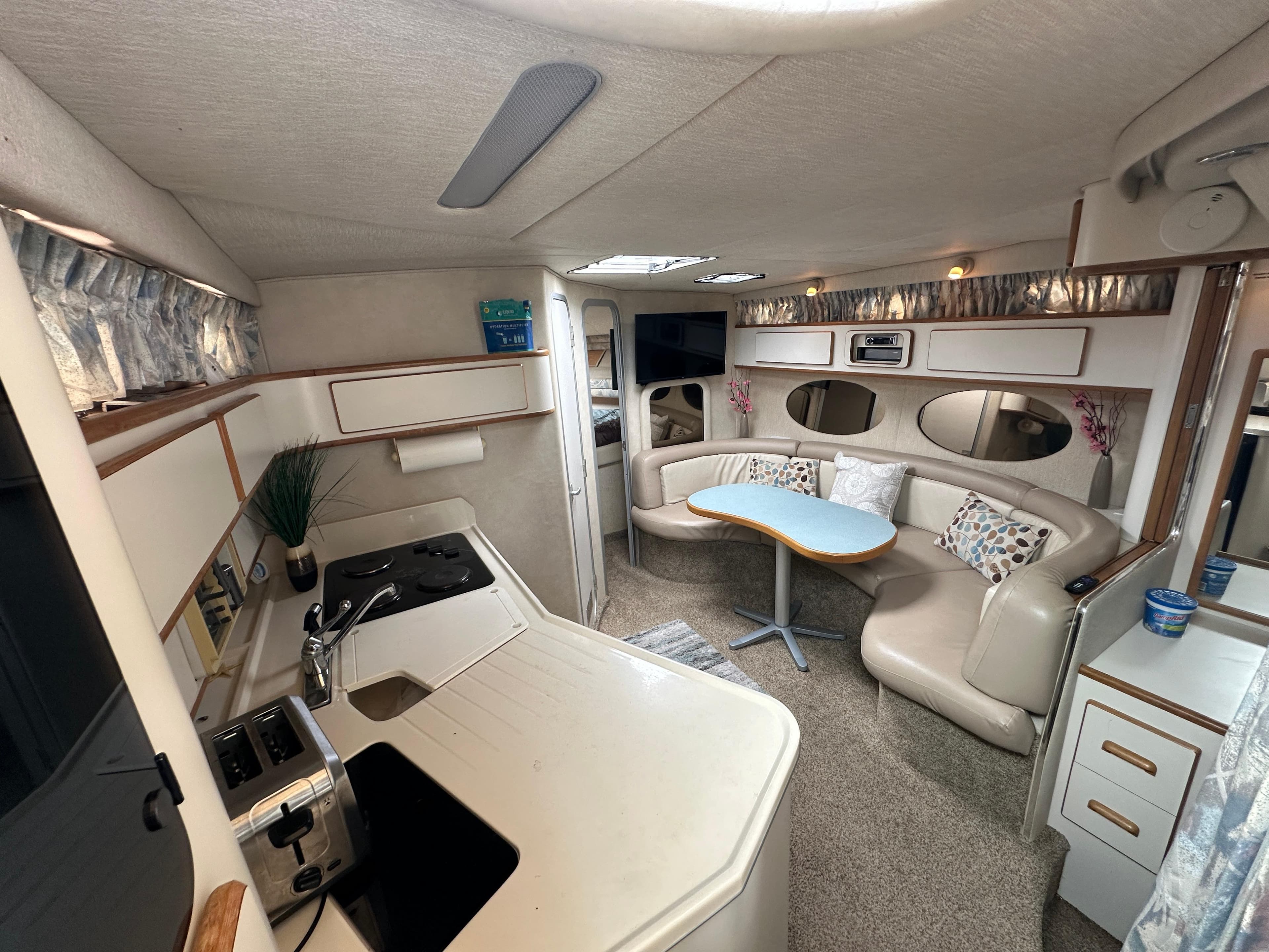 Luxurious interior of 1994 Sea Ray 370 Sundancer yacht with kitchen and seating area.
