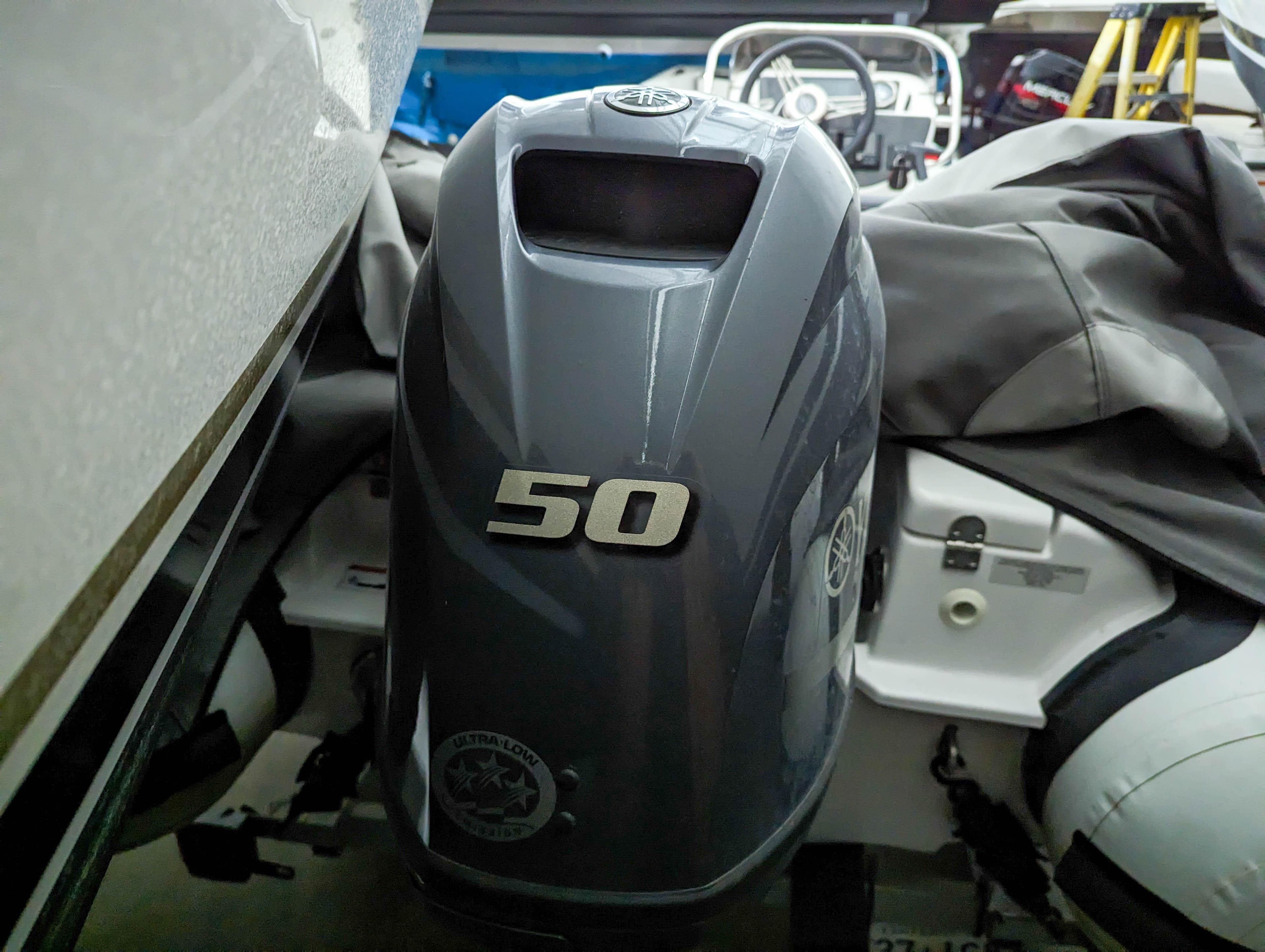 2022 Walker Bay Generation 400 with 50 HP outboard motor, covered and stored indoors.