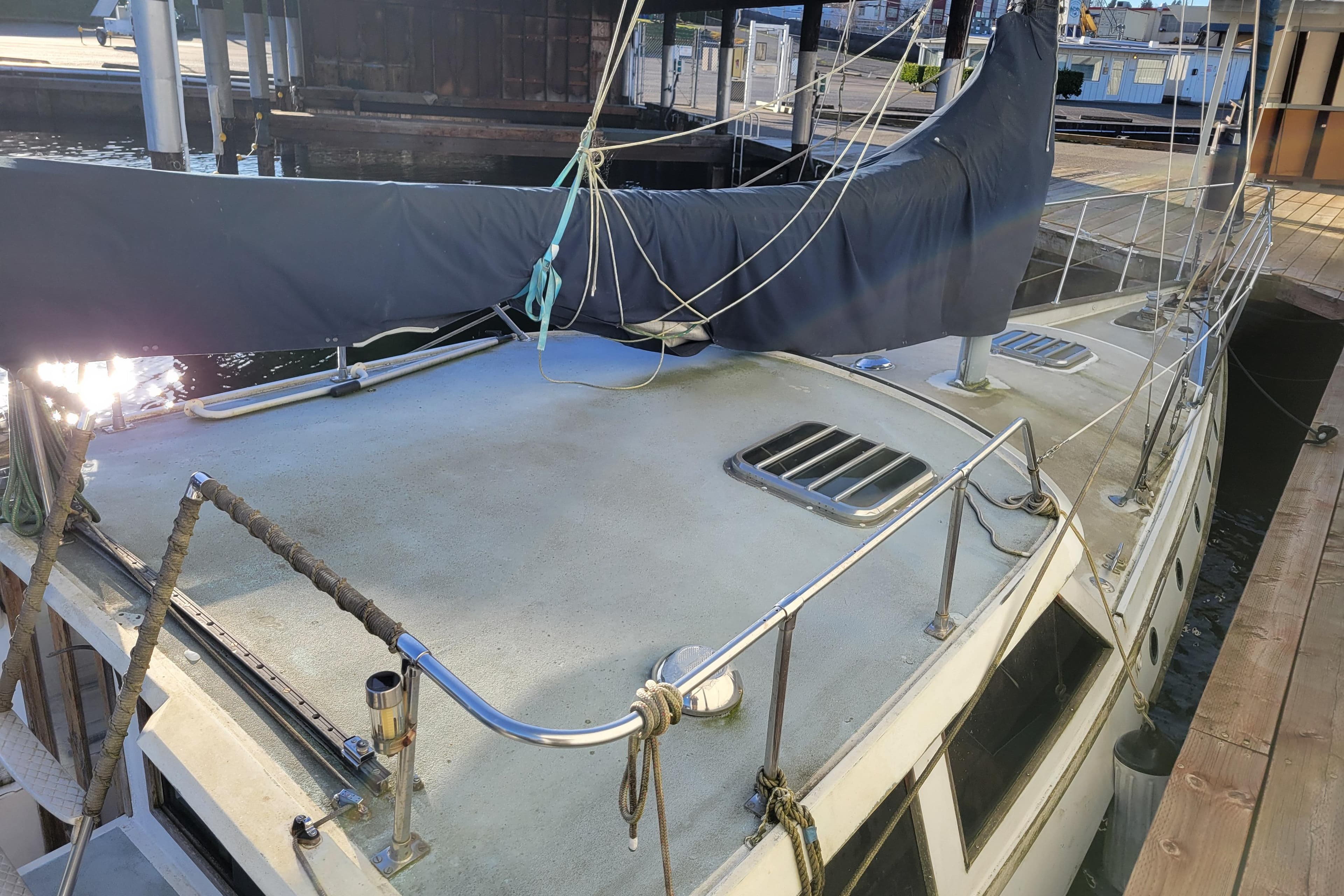 1983 Limited Edition Pilothouse Sloop docked, featuring covered sails and deck details.