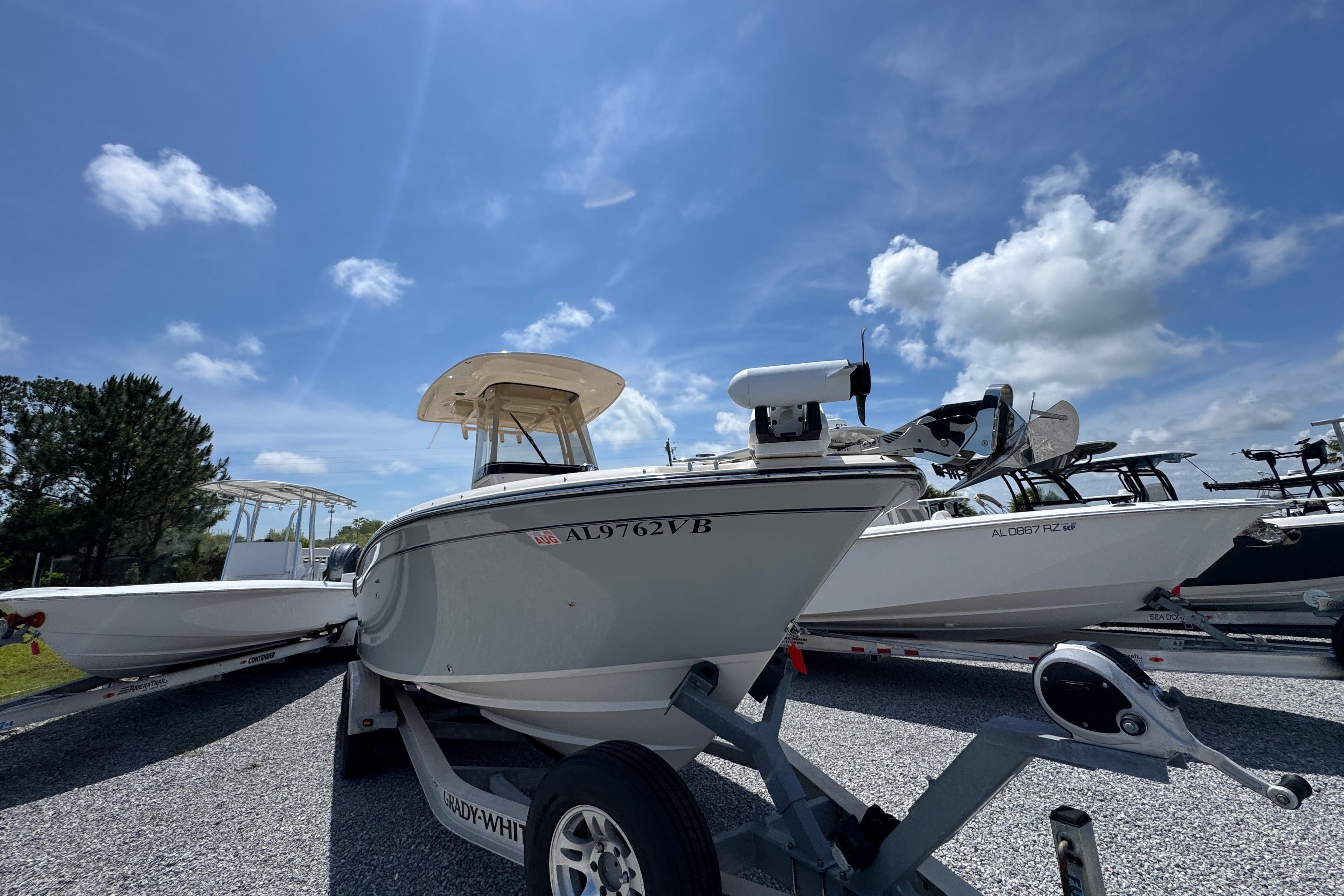 2022 Grady-White Fisherman 257 boat on trailer under clear blue sky.