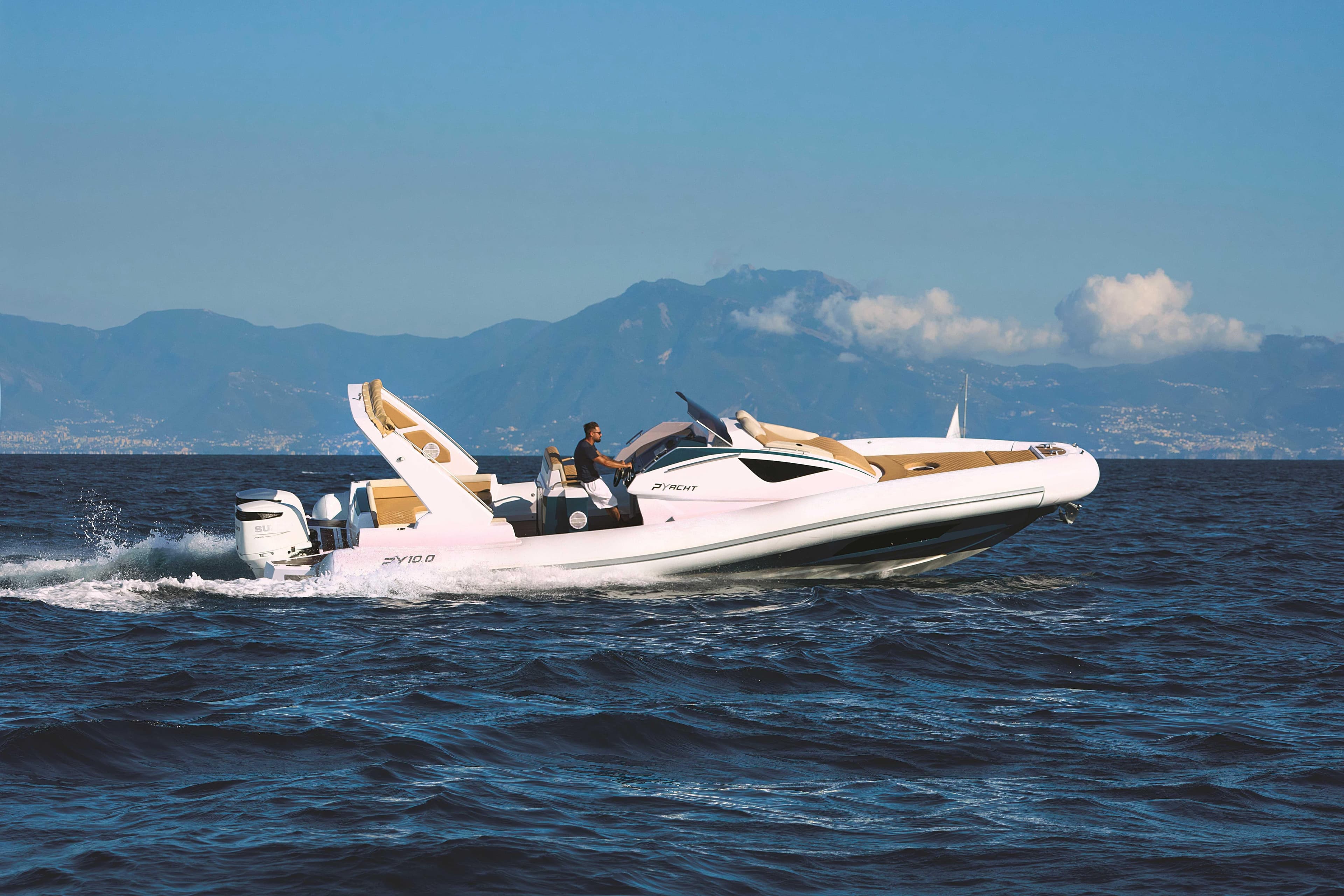 2025 Panamera Yacht PY 10 Cabin cruising on open sea with mountainous backdrop.
