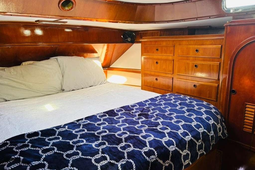 Luxurious cabin interior of 1982 Steven Custom Stevens 47 yacht with wooden cabinetry.