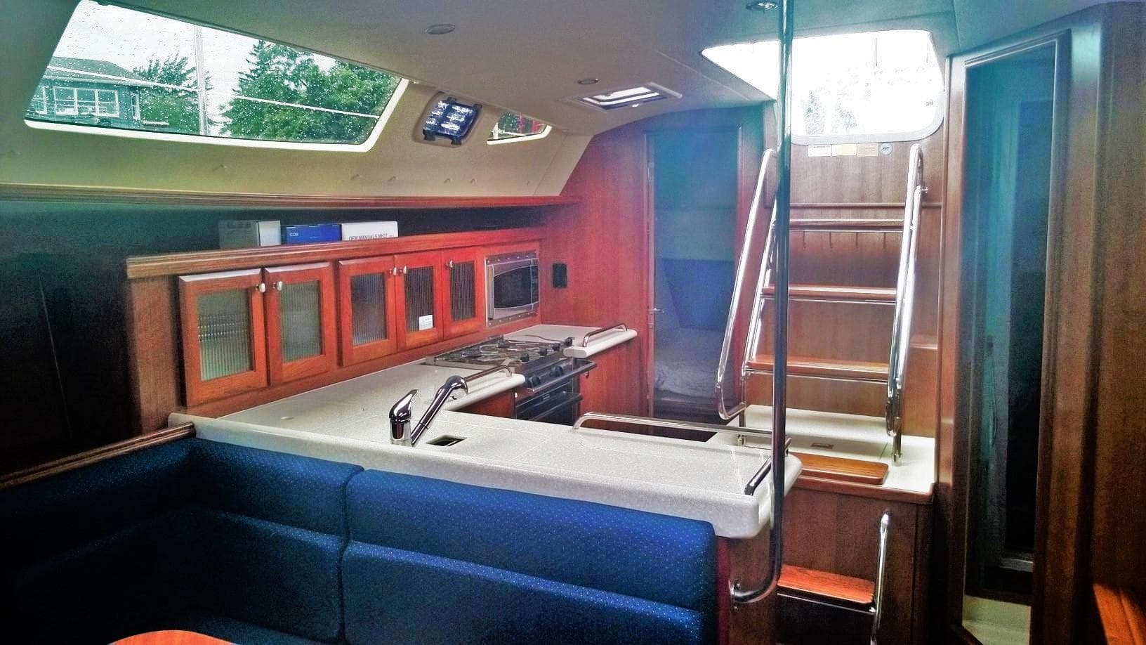 Interior of 2015 Marlow-Hunter 37 yacht with modern kitchen and seating area.