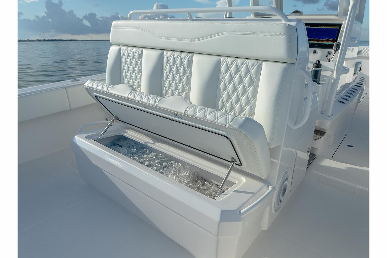 Manufacturer Provided Image: 2026 Invincible 33 Catamaran with luxurious seating and built-in cooler on a serene water backdrop.