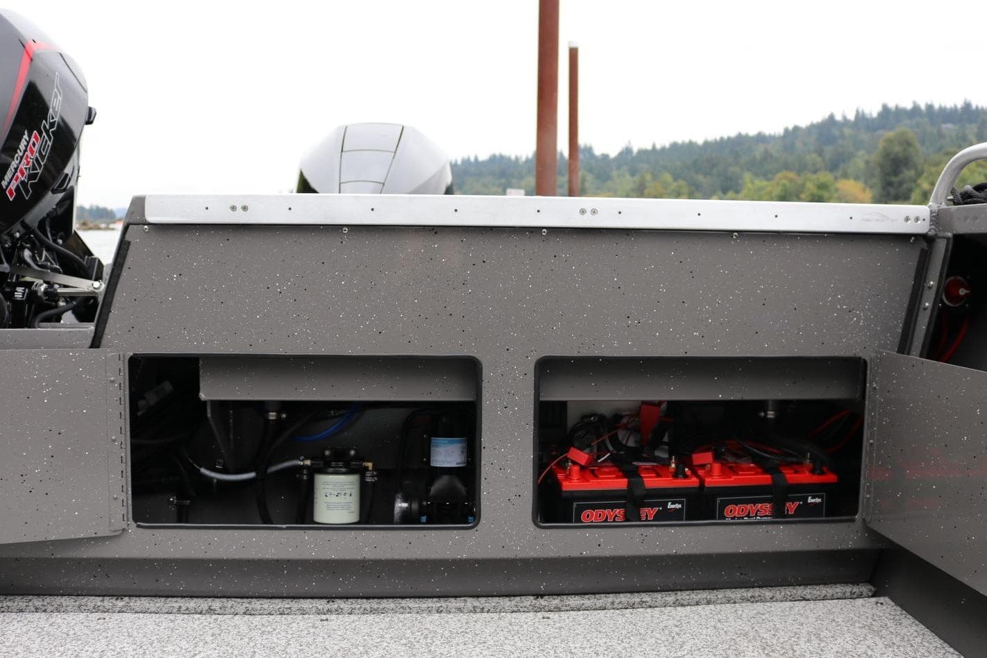 2026 Alumaweld Intruder 22 boat showing engine compartment and battery storage.
