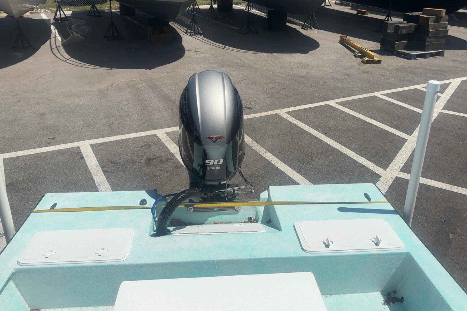 2025 Custom Mangrove Coast Boats 1700 Harbor Hawk with Yamaha 90 engine in parking lot.