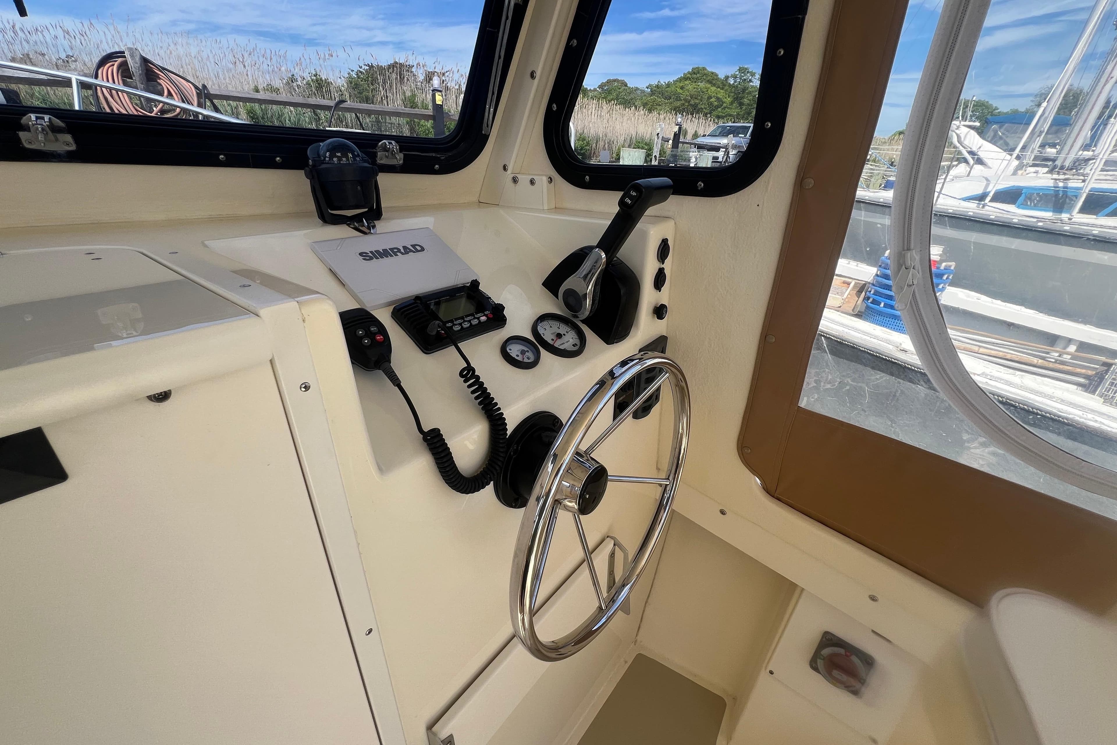2020 Eastern 22 Sisu Hardtop boat helm with steering wheel and navigation controls.