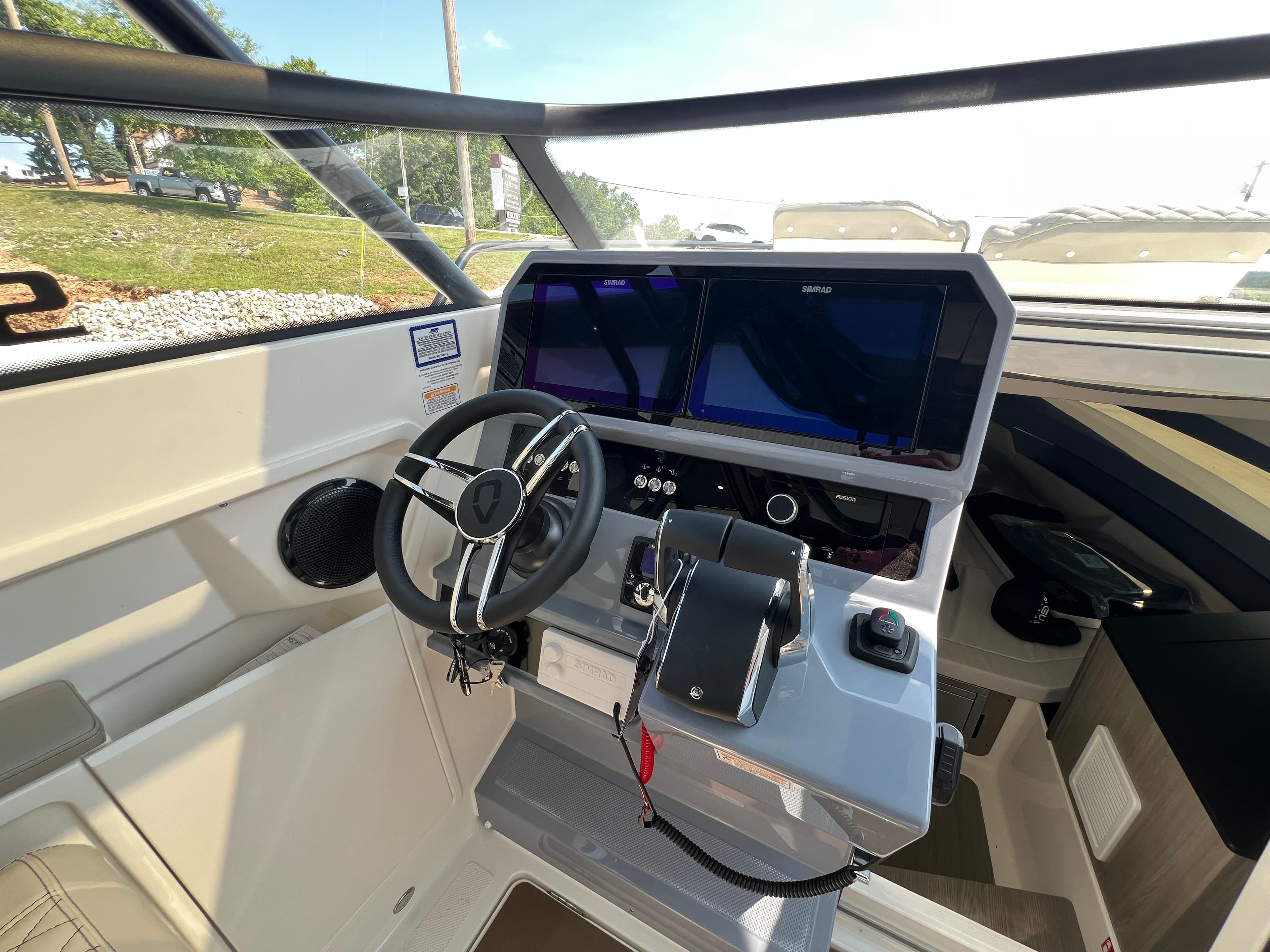 Navan S-30 2025 boat cockpit with steering wheel and dual navigation screens.