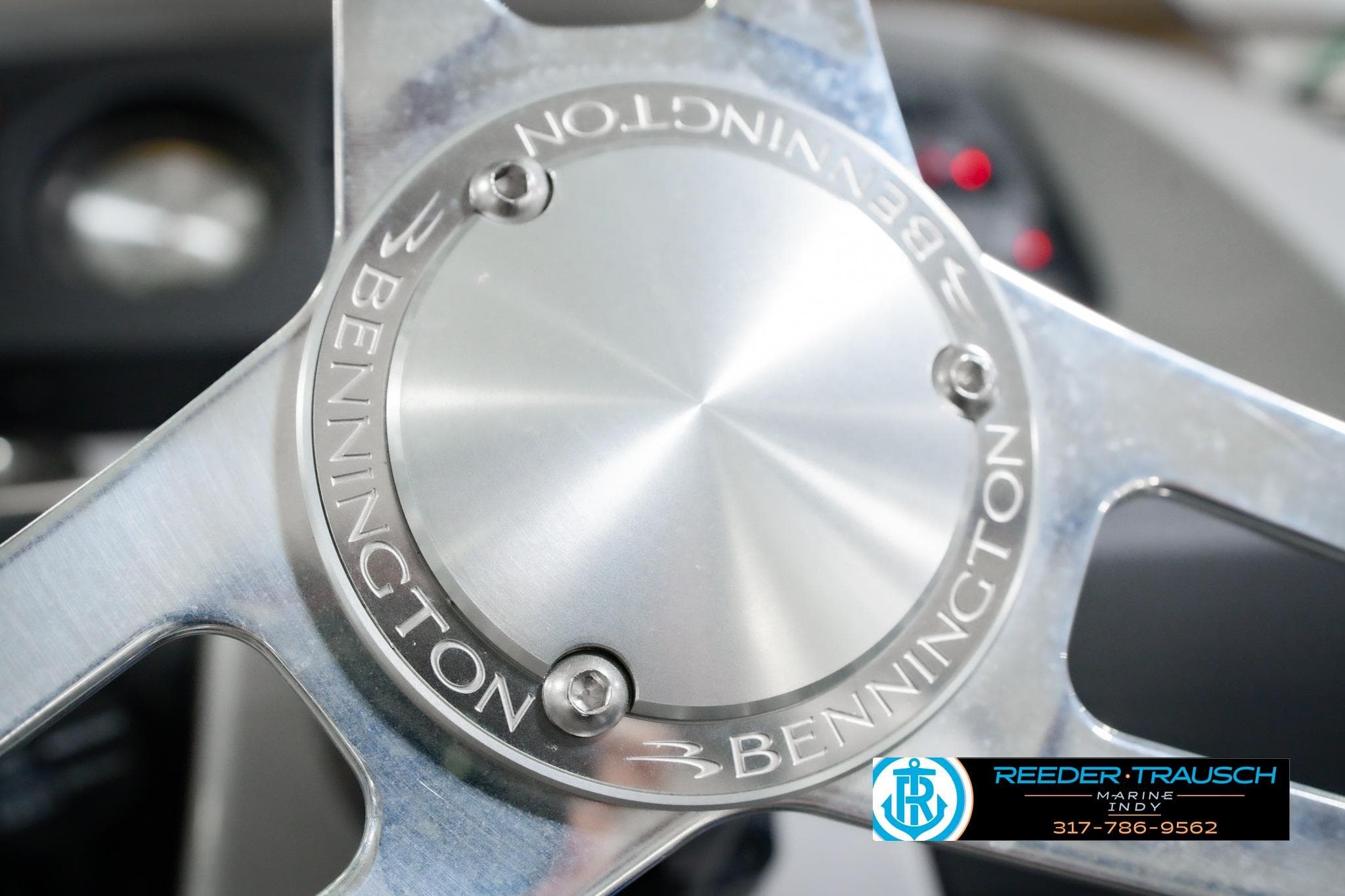 Close-up of 2026 Bennington 22 SXSAPG steering wheel with logo engraving.