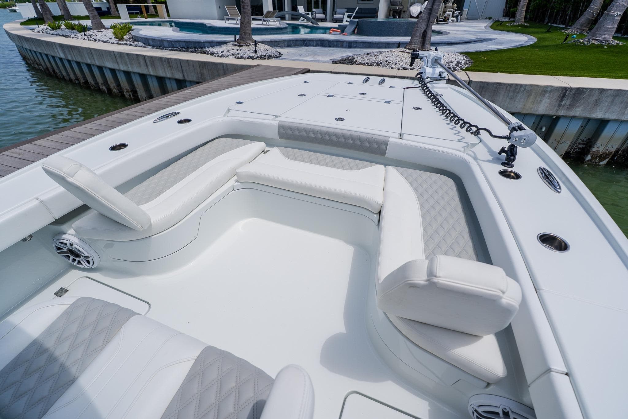Luxurious seating area on a 2023 Freeman 28 boat, docked by a waterfront.