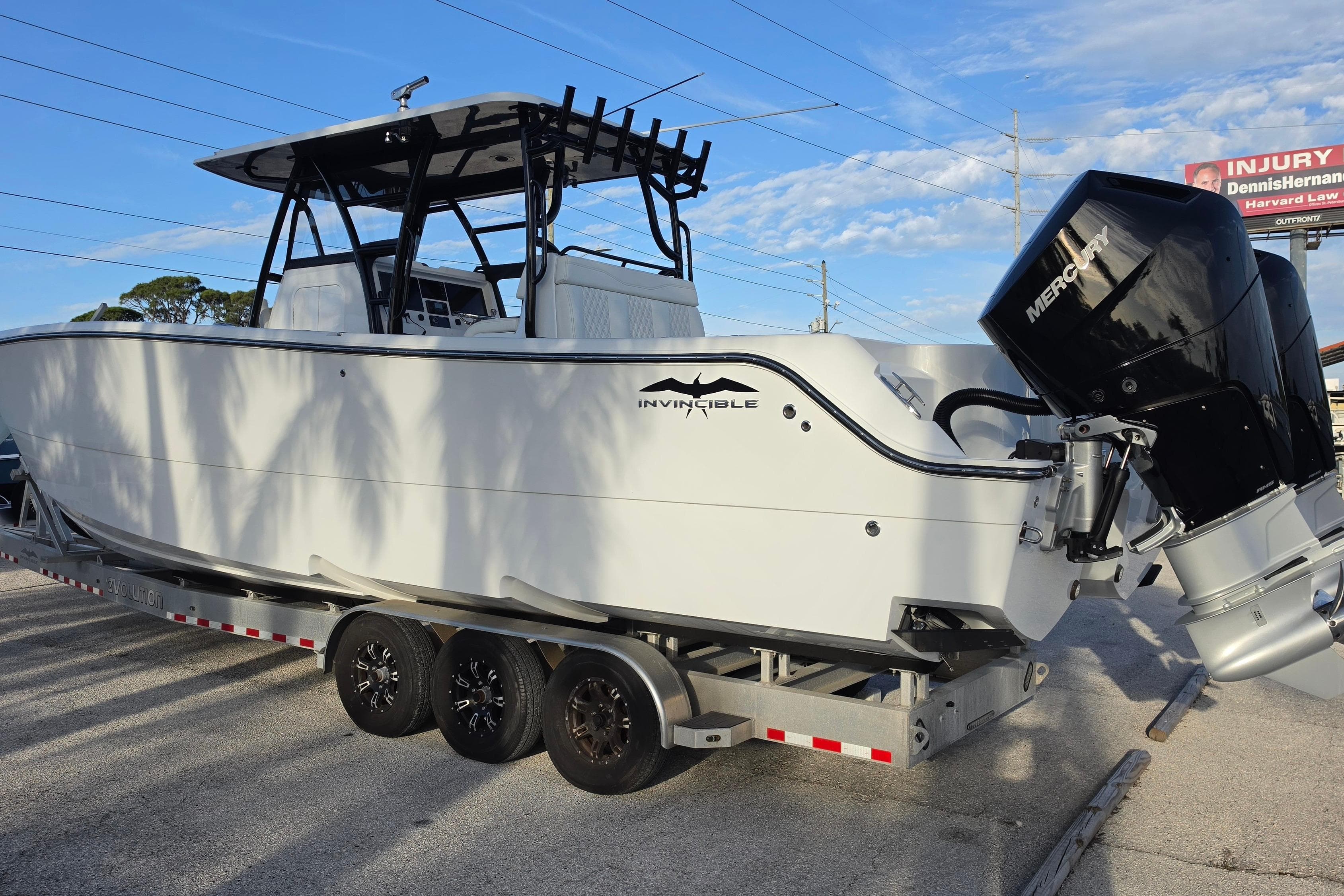 2026 Invincible 33 Catamaran on trailer with Mercury outboard motor.