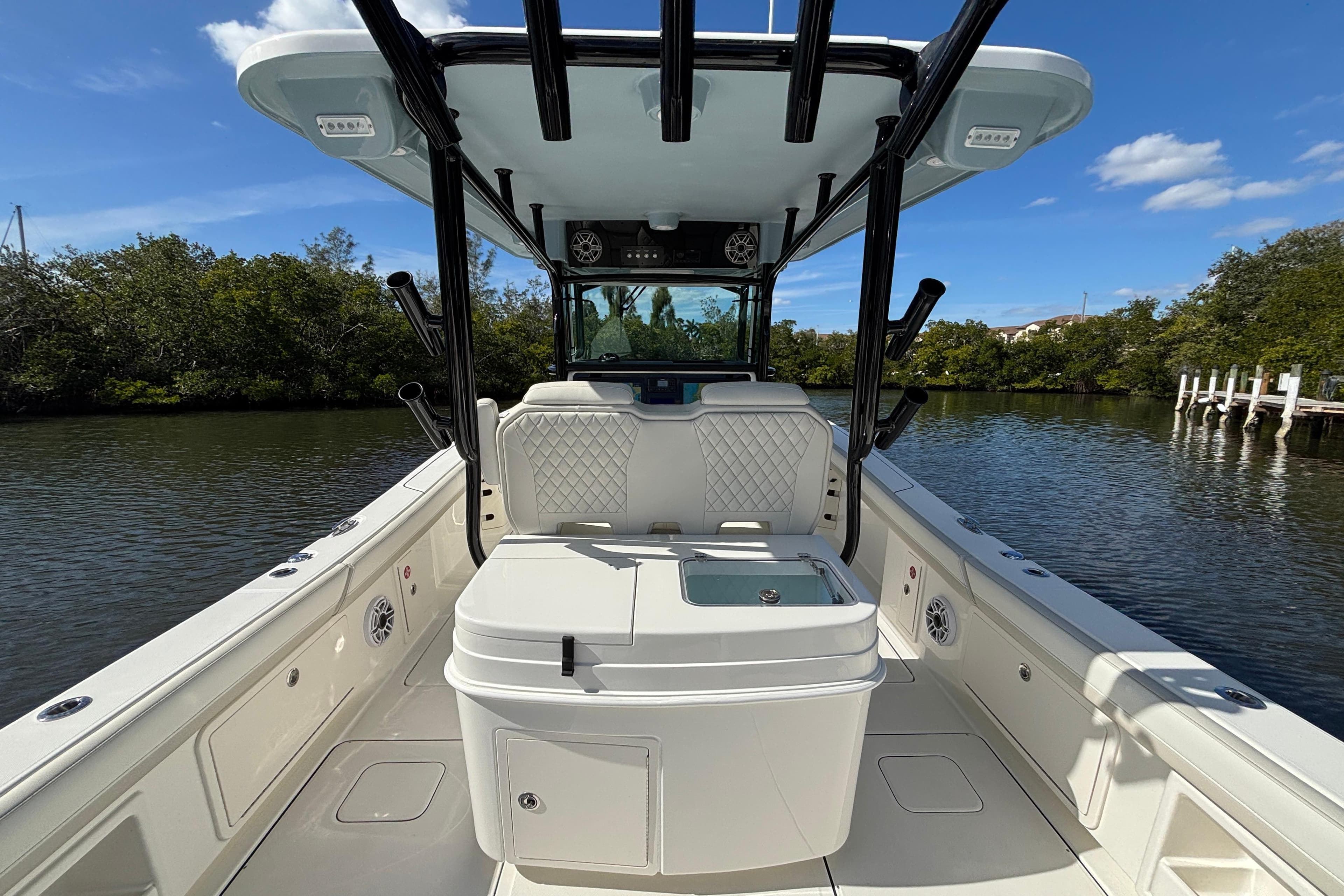 2026 World Cat 325 CC boat interior with seating and storage, on a calm river.