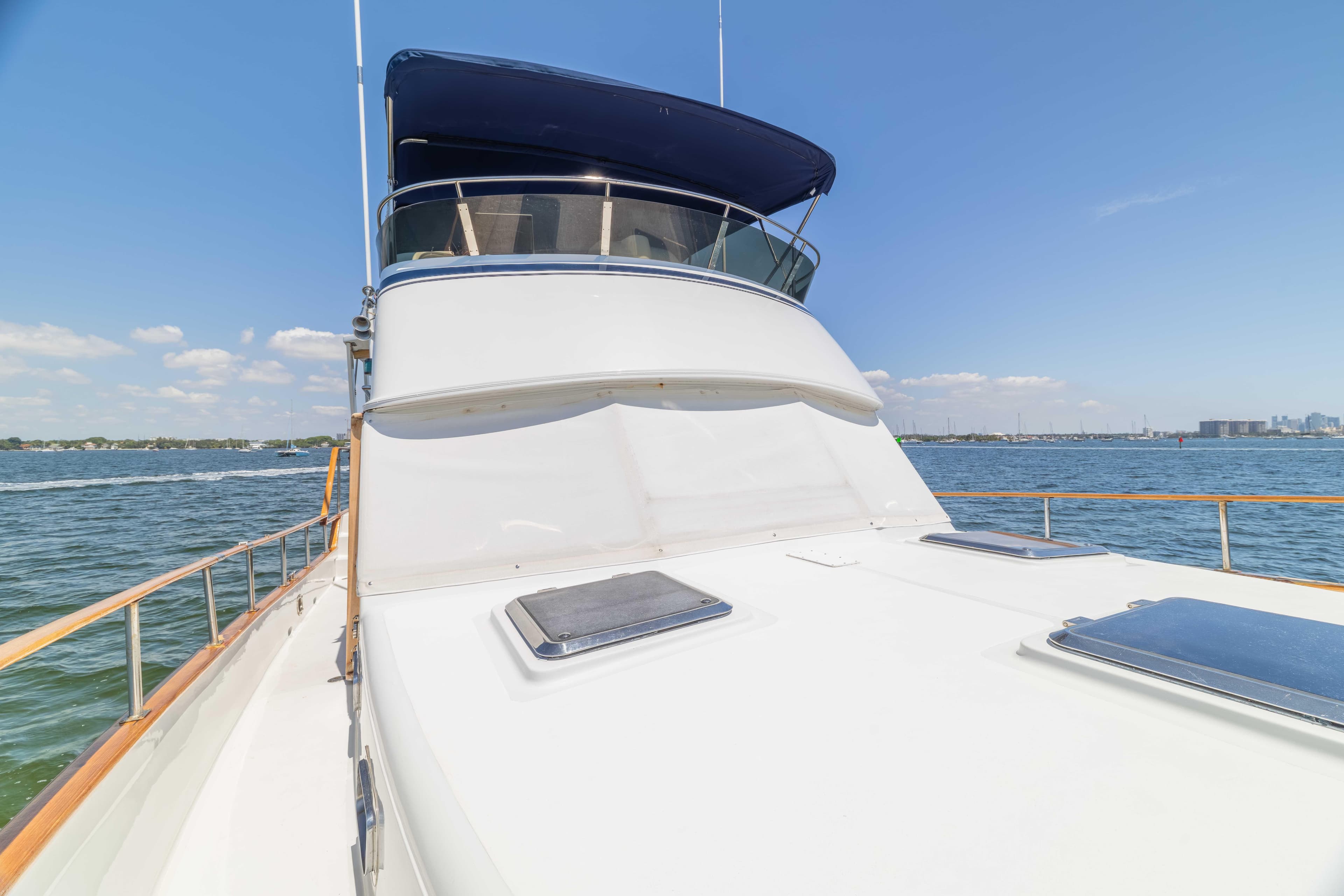 1983 Sea Ranger 45 Sundeck yacht on calm waters under clear blue sky.