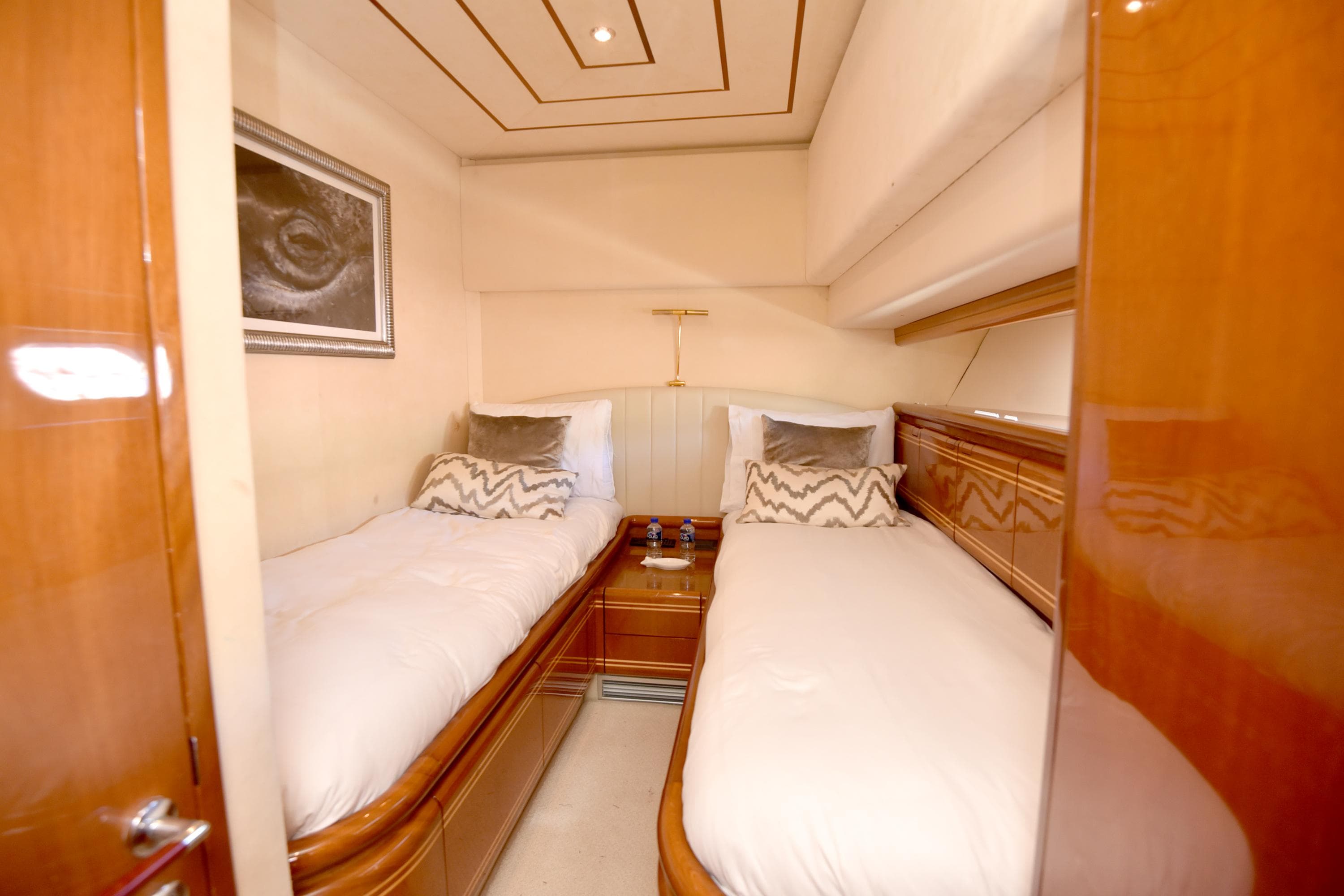 Twin cabin interior of 1997 Ferretti Yachts 80 with wooden finishes and modern decor.