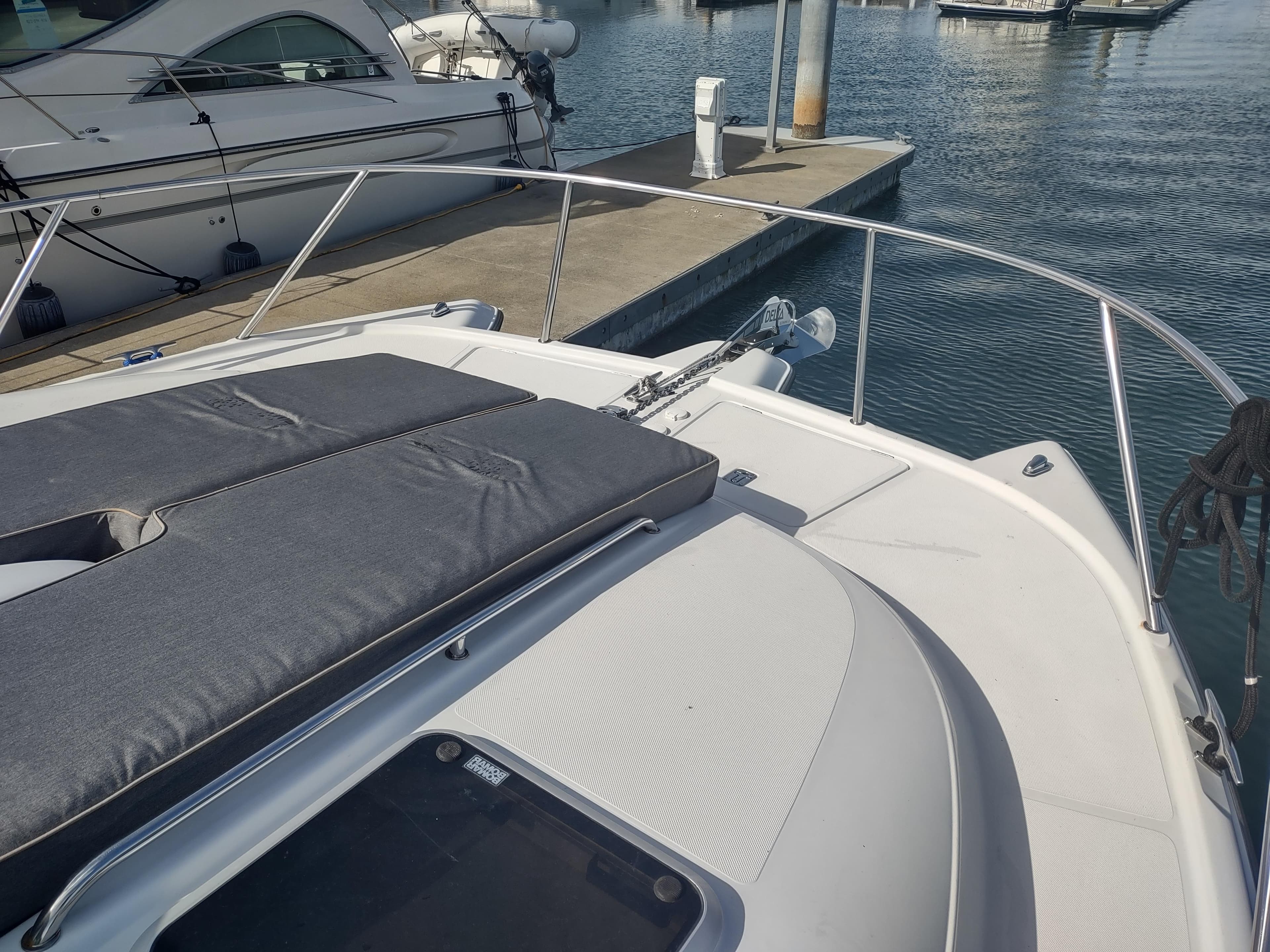 2005 Glacier Bay 3490 Ocean Runner boat docked at marina, featuring spacious deck.