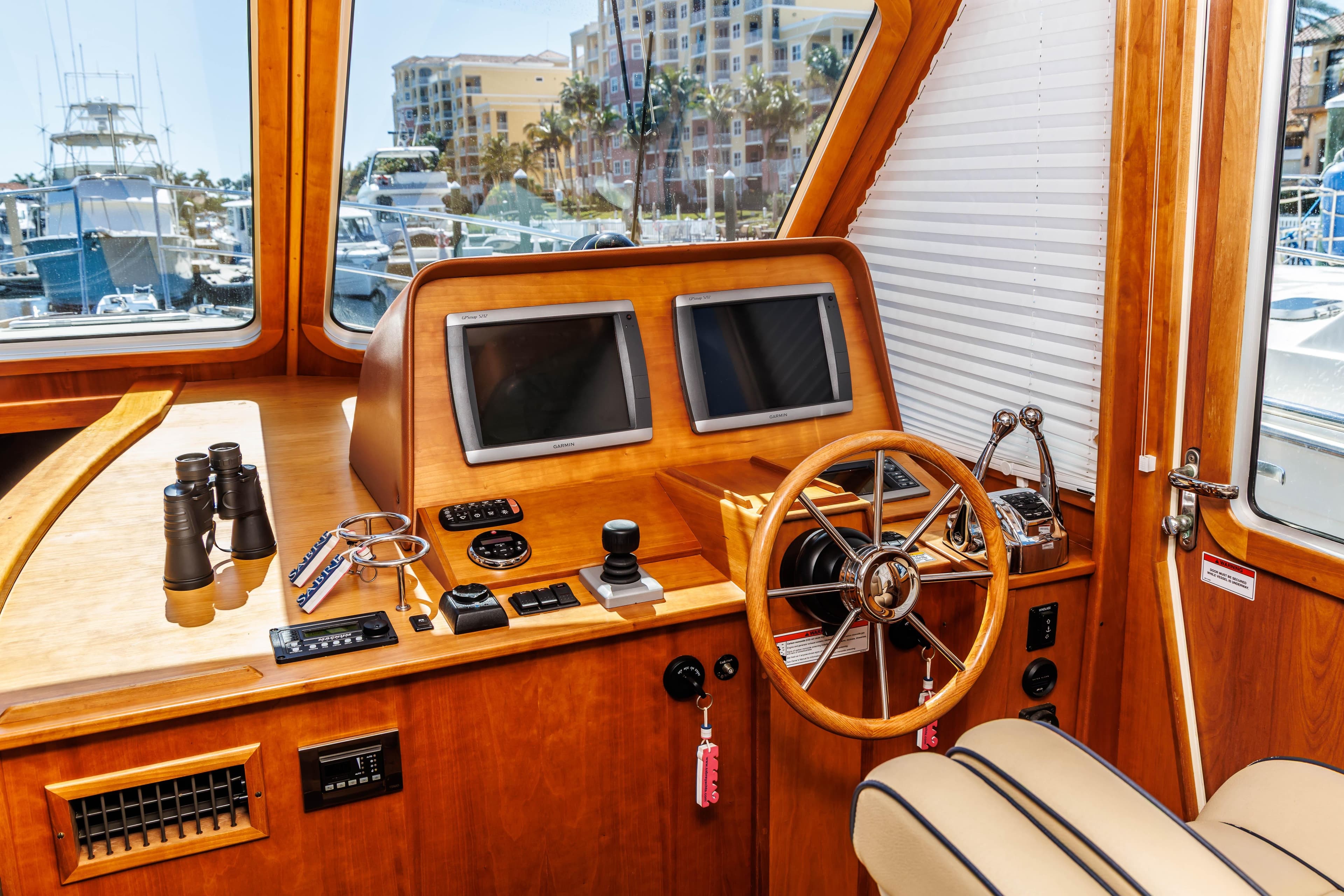 Interior of 2010 Sabre 40 Sedan yacht with wooden helm and navigation equipment.