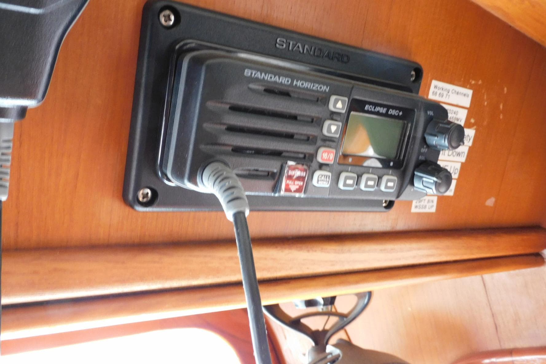 VHF radio on 1988 Hans Christian 45 Independence Trawler, mounted on wooden panel.