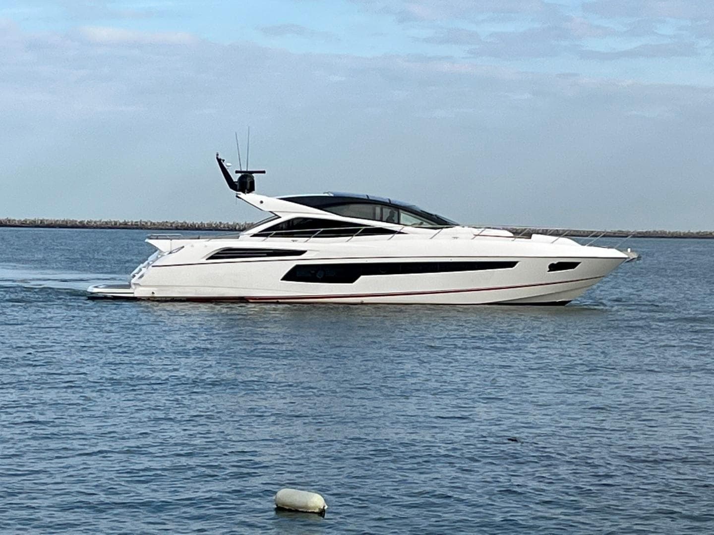 2014 Sunseeker 68 Predator yacht cruising on calm waters.