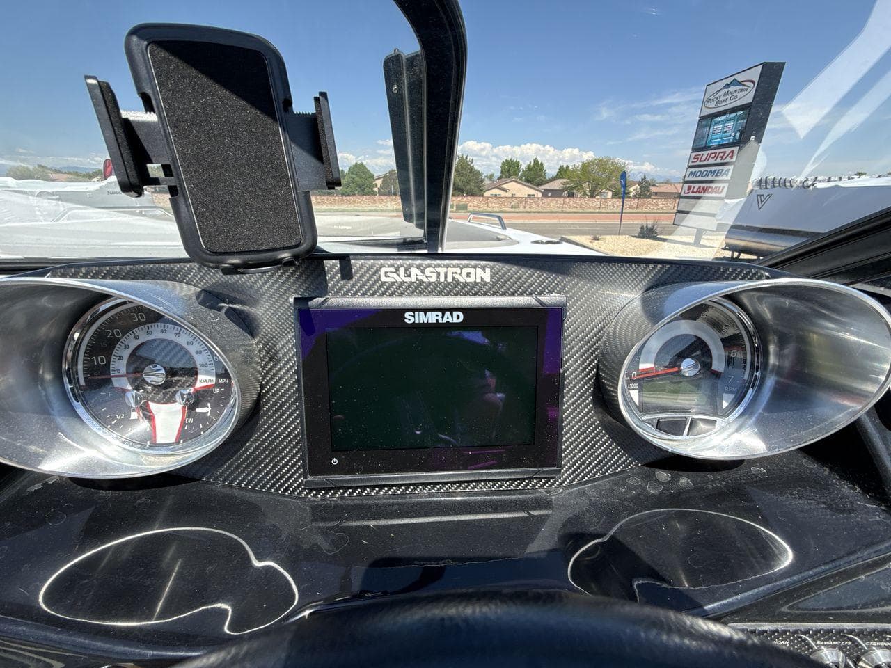 Dashboard of 2022 Glastron GTD 245 boat with Simrad display and gauges.