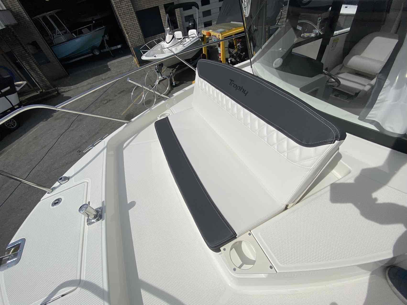 2024 Bayliner Trophy T25 Pilothouse boat with cushioned seating on deck.