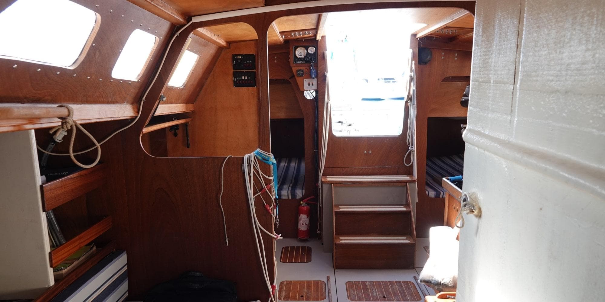 Cozy wooden boat interior with steps, windows, and nautical equipment, DanielP1Tester One-Off Design, 2012.
