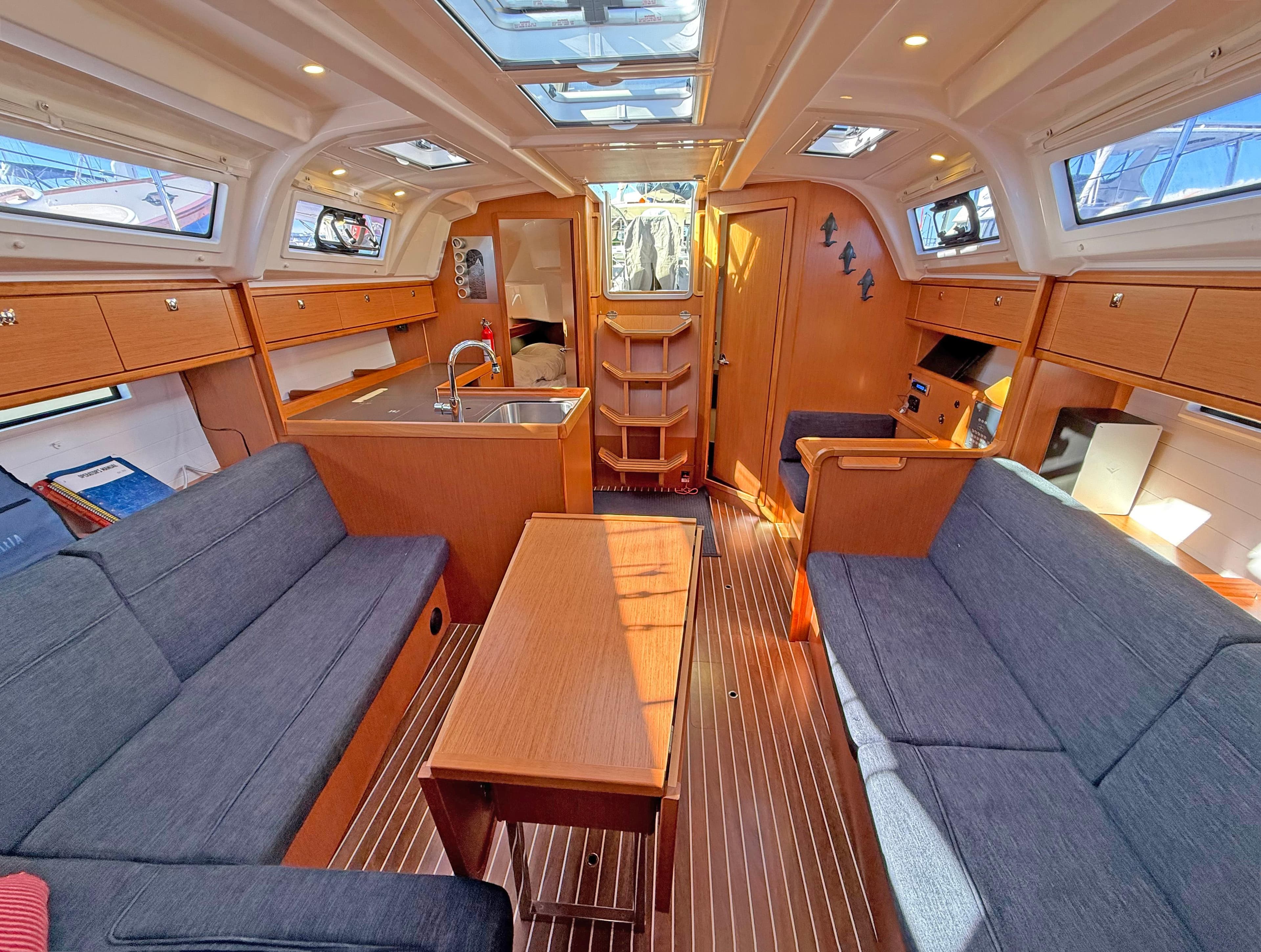Interior of 2015 Bavaria Cruiser 37 yacht with modern wood finish and spacious seating.