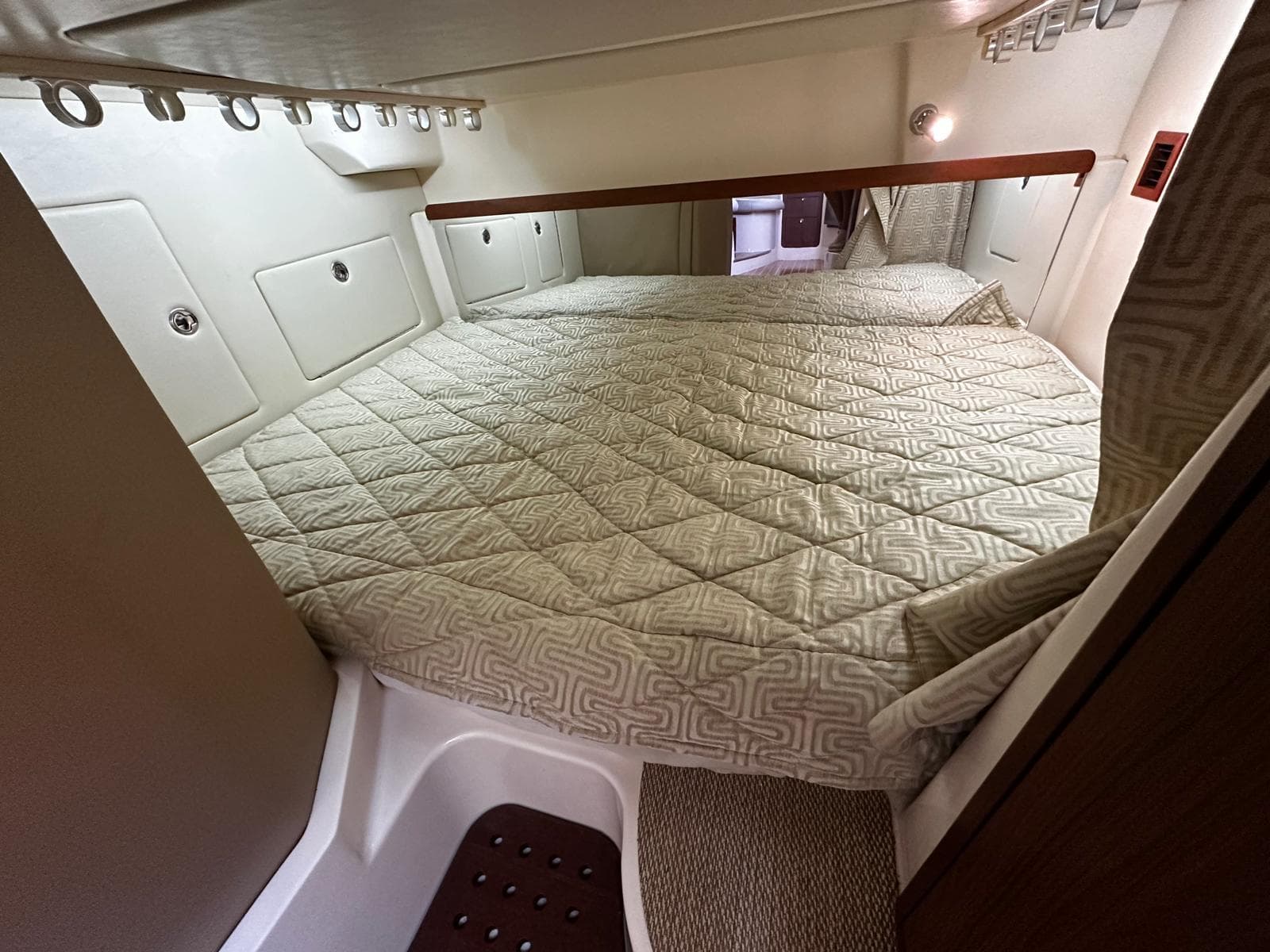 2016 Grady-White Express 370 cabin interior with a cozy bed and modern design.
